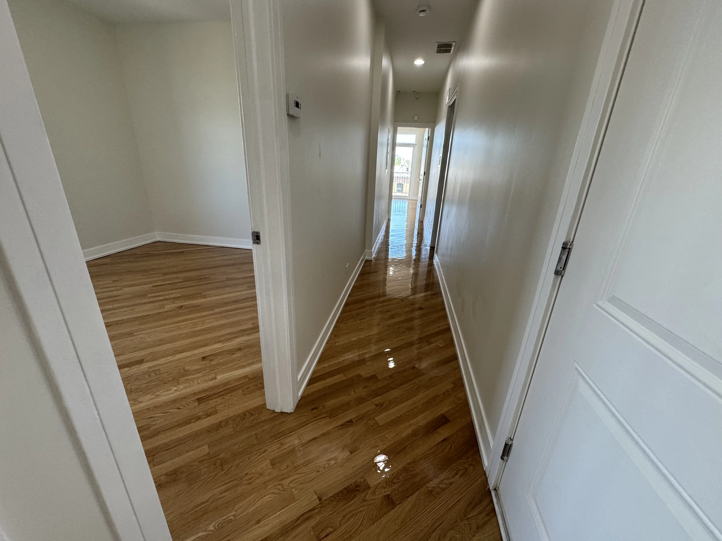 Hardwood flooring refinished with restored color and a durable protective topcoat in a Romeoville home