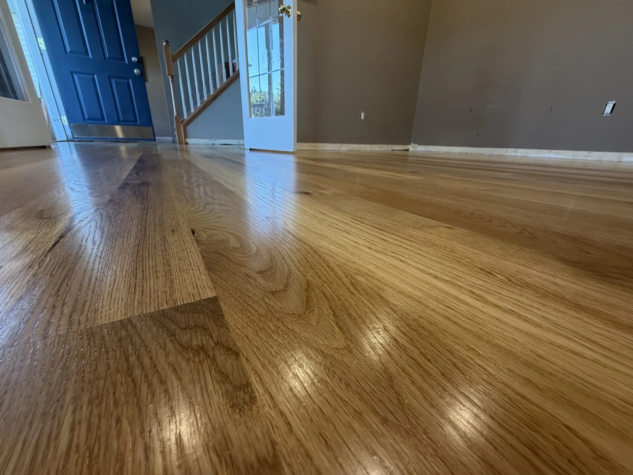 Refinished hardwood flooring with restored color and a durable protective coating in a Sandwich home
