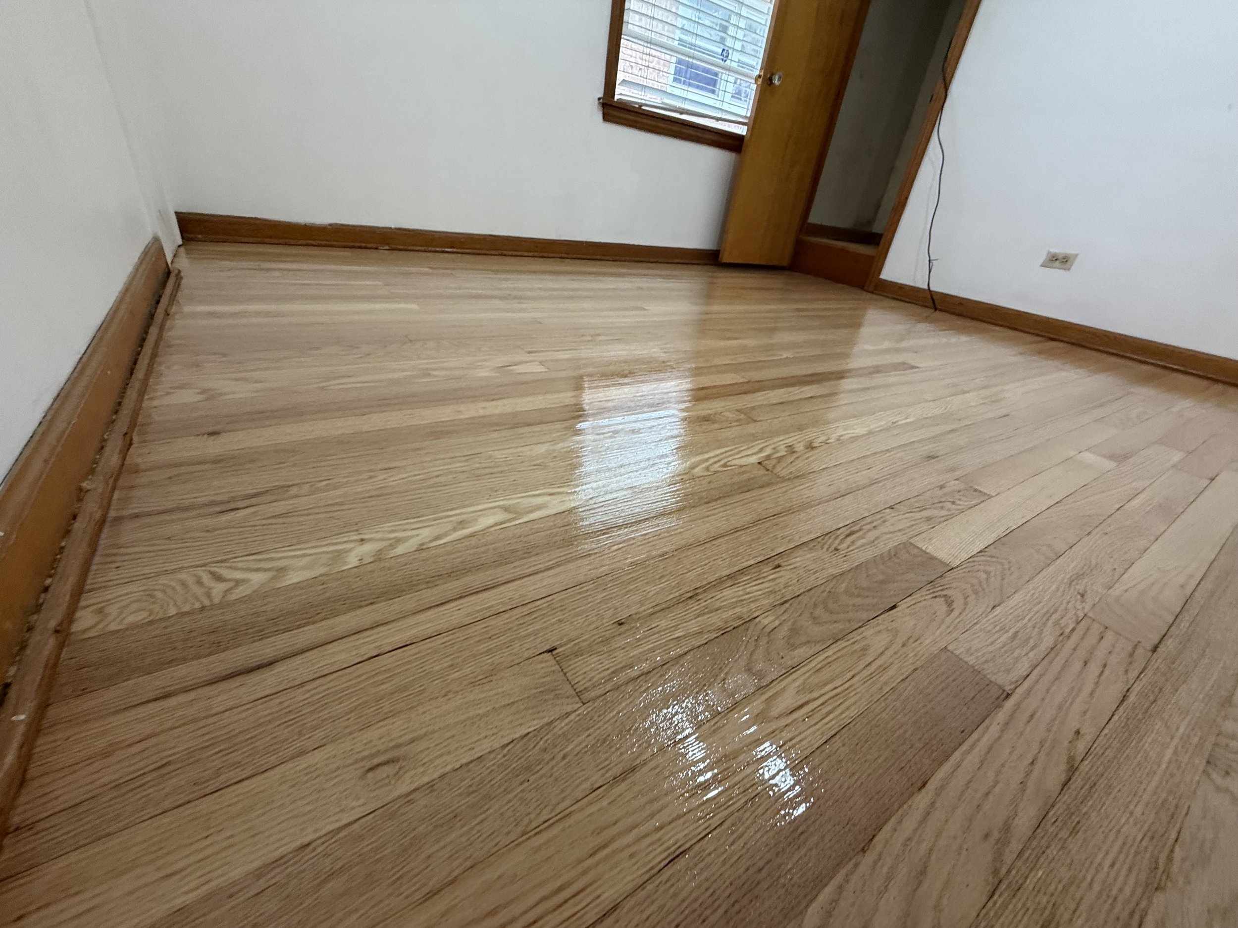 Refinished hardwood floor with restored color and a durable protective finish in a La Grange Park home