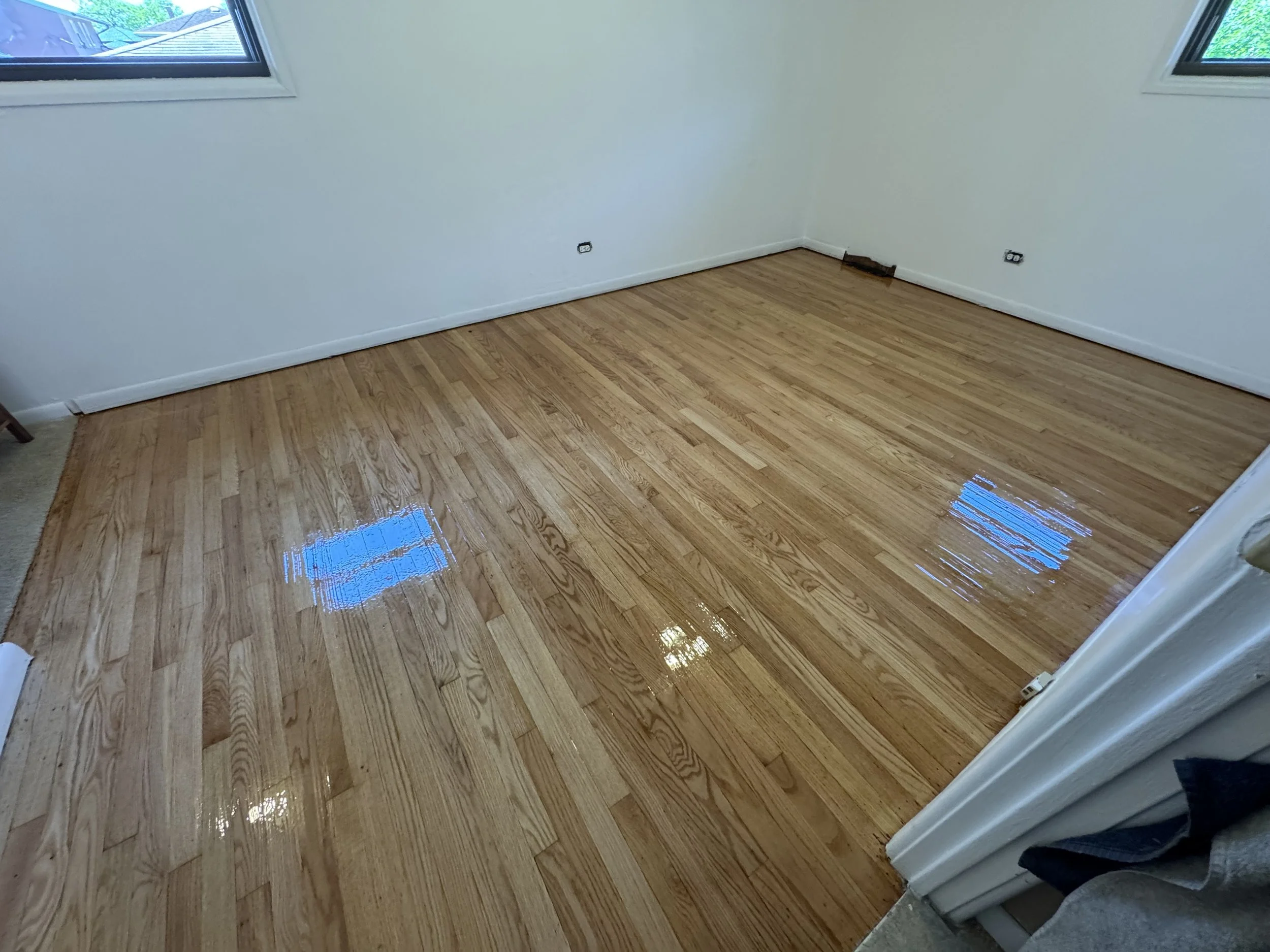 Hardwood flooring refinished with restored natural color and durable protective finish in a Chicago Heights home
