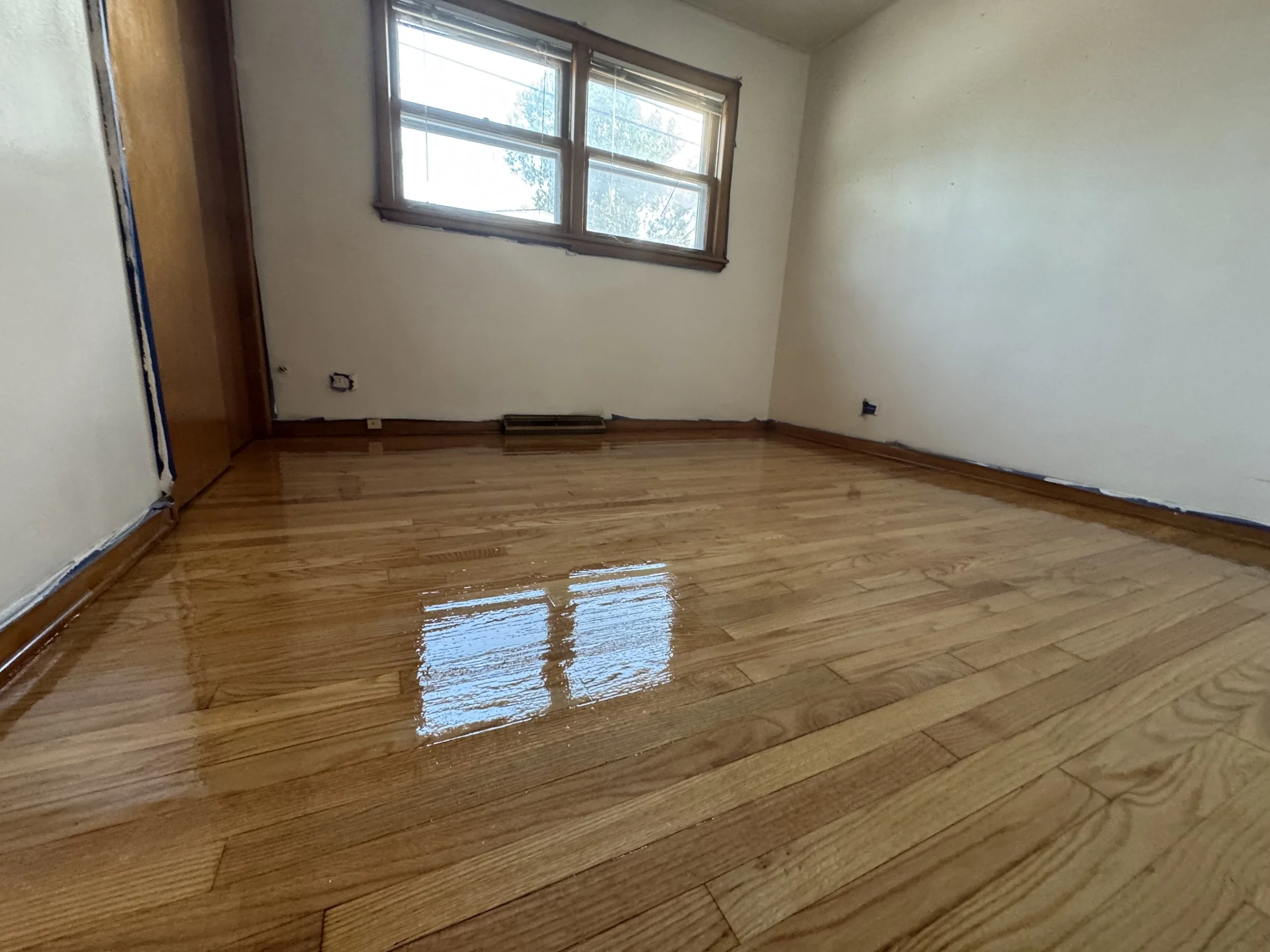 Hardwood flooring refinished with renewed natural tone and durable protective finish in a Midlothian home