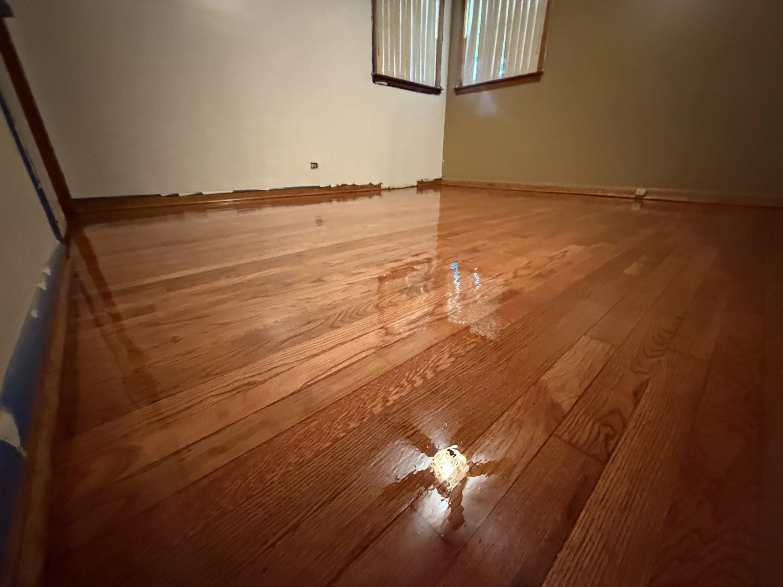Hardwood floor refinished with restored color and a durable protective finish in a Summit home