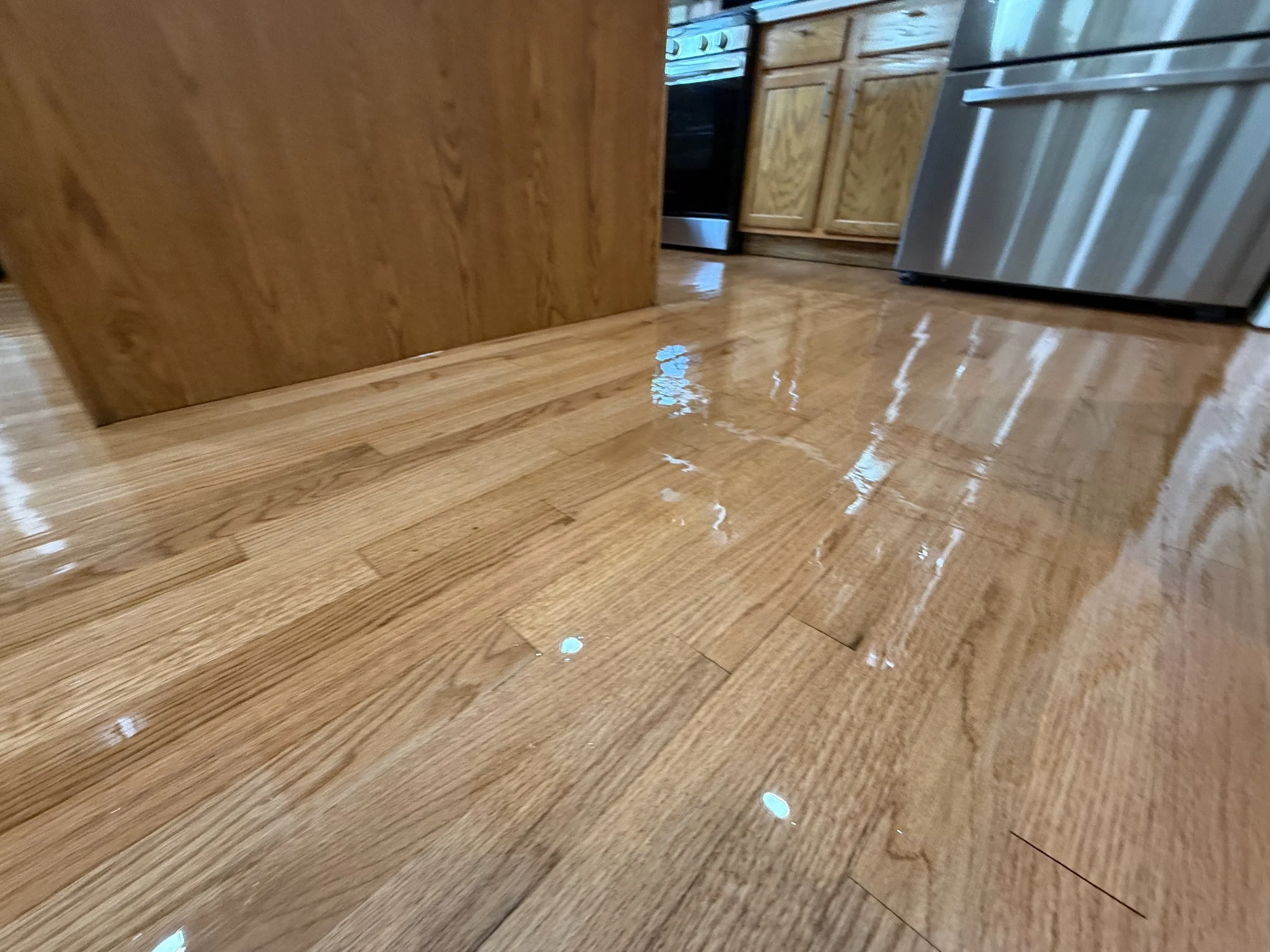 Hardwood floor refinished to reveal its natural grain and rich wood tone
