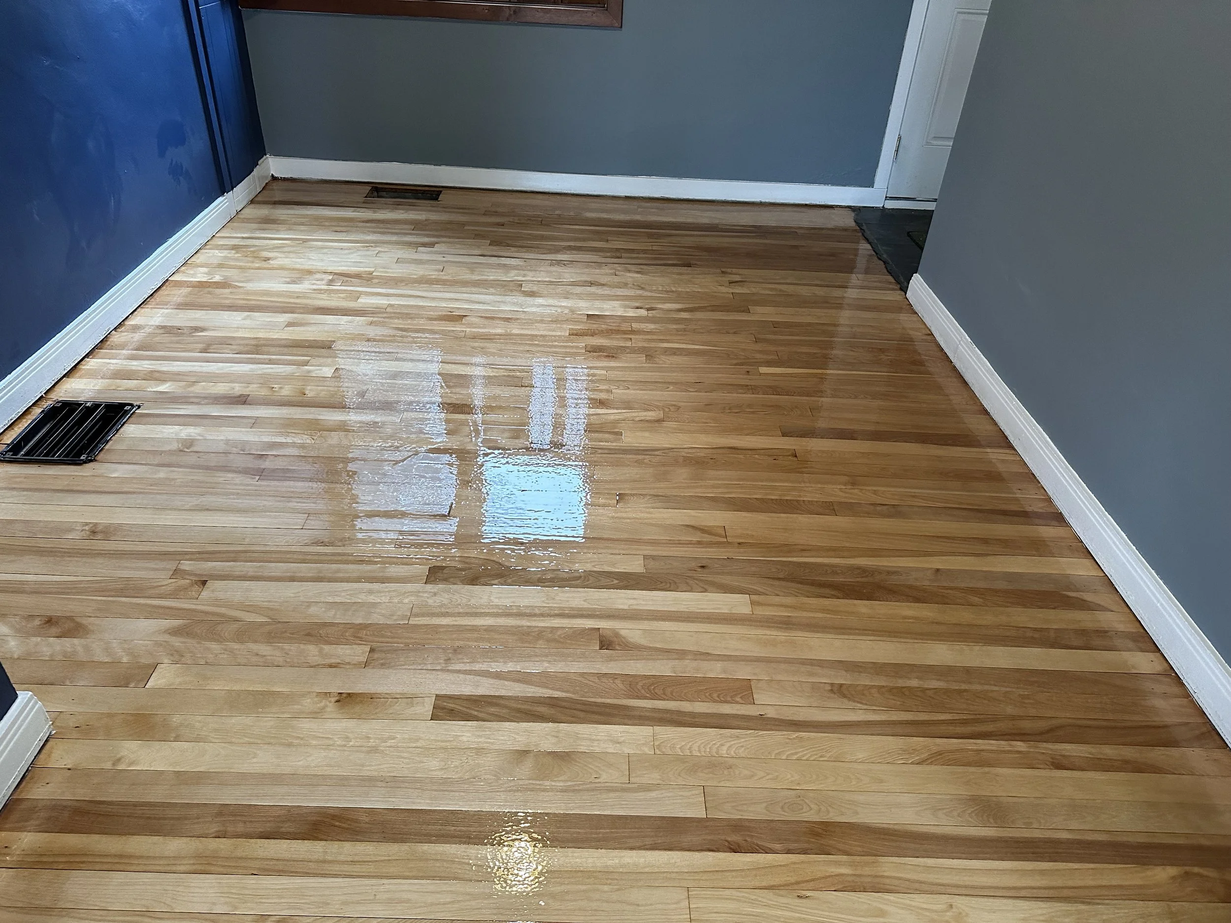 Hardwood floor refinished with an even natural wood finish