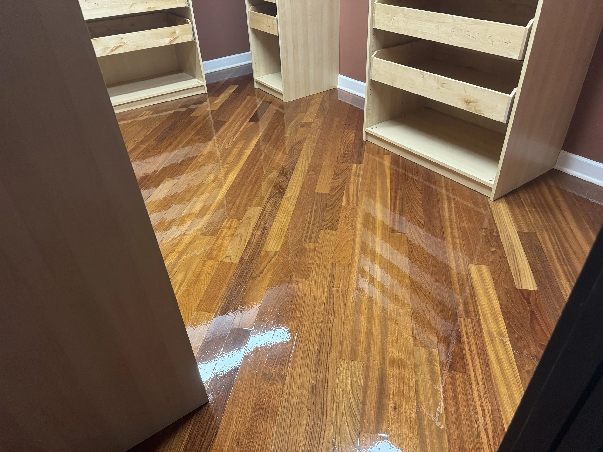 Refinished hardwood flooring with restored wood grain and a long-lasting protective coating