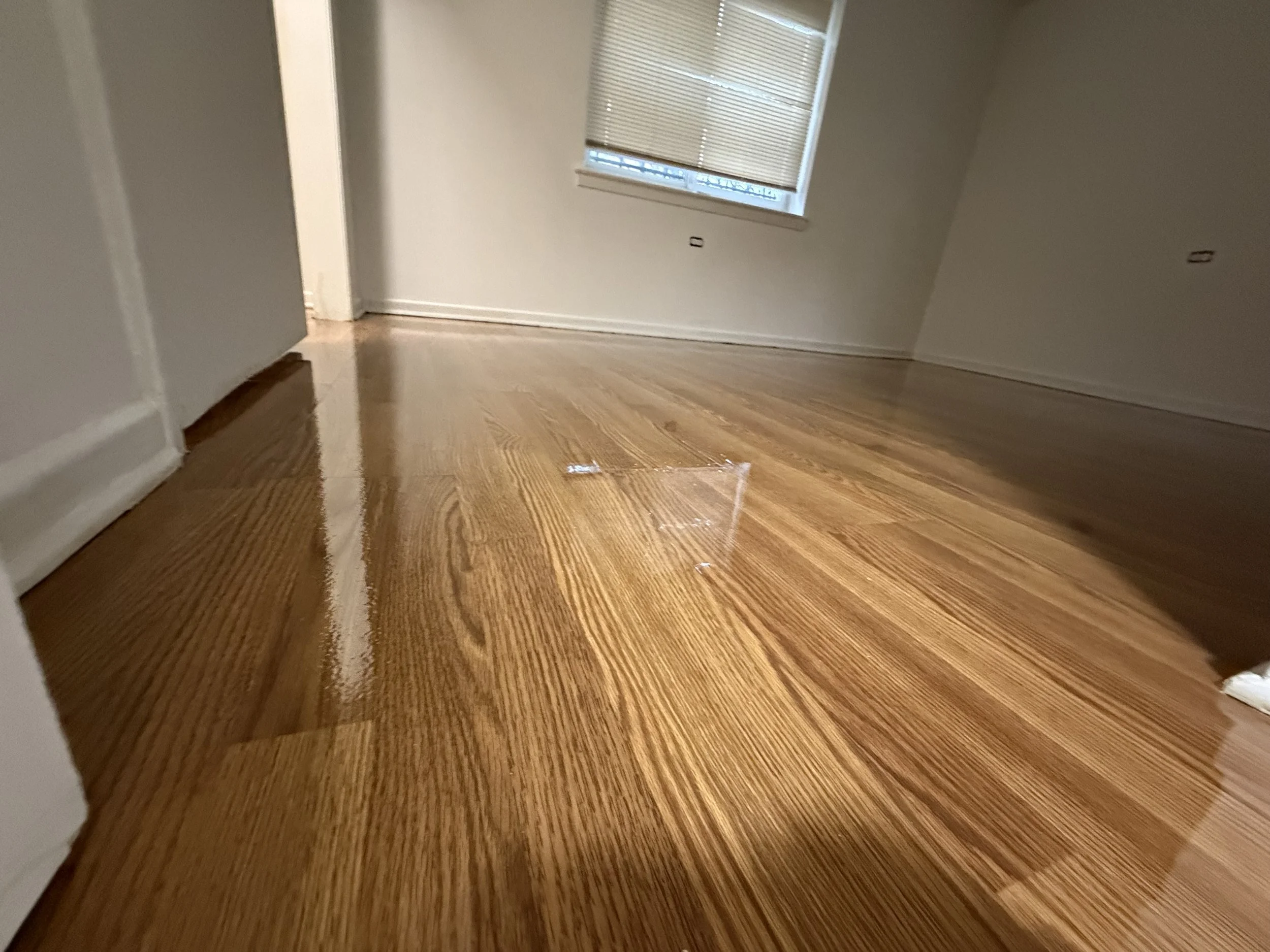 Hardwood flooring refinished with restored wood grain and durable protective finish in a Burbank home