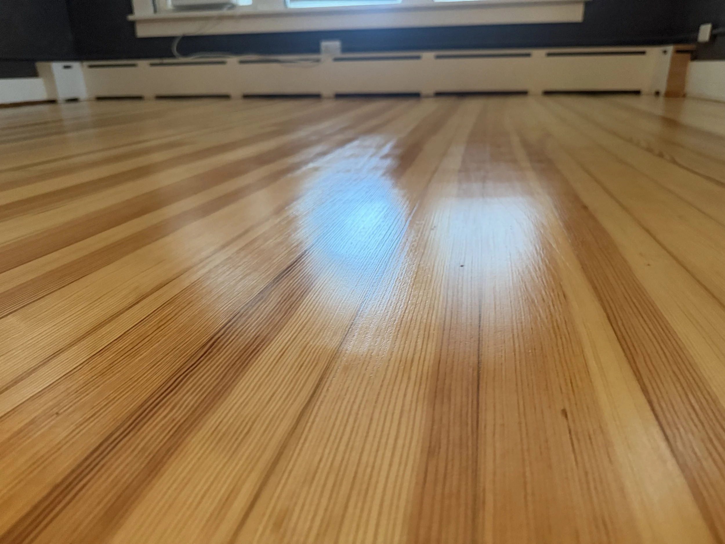 Restored hardwood floor with renewed color and clear protective finish