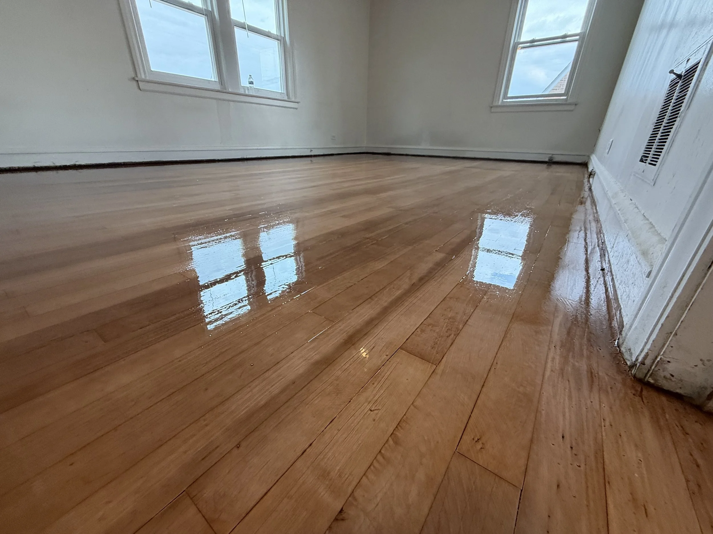 Refinished hardwood flooring with restored natural grain and a durable protective finish in a Hinsdale home
