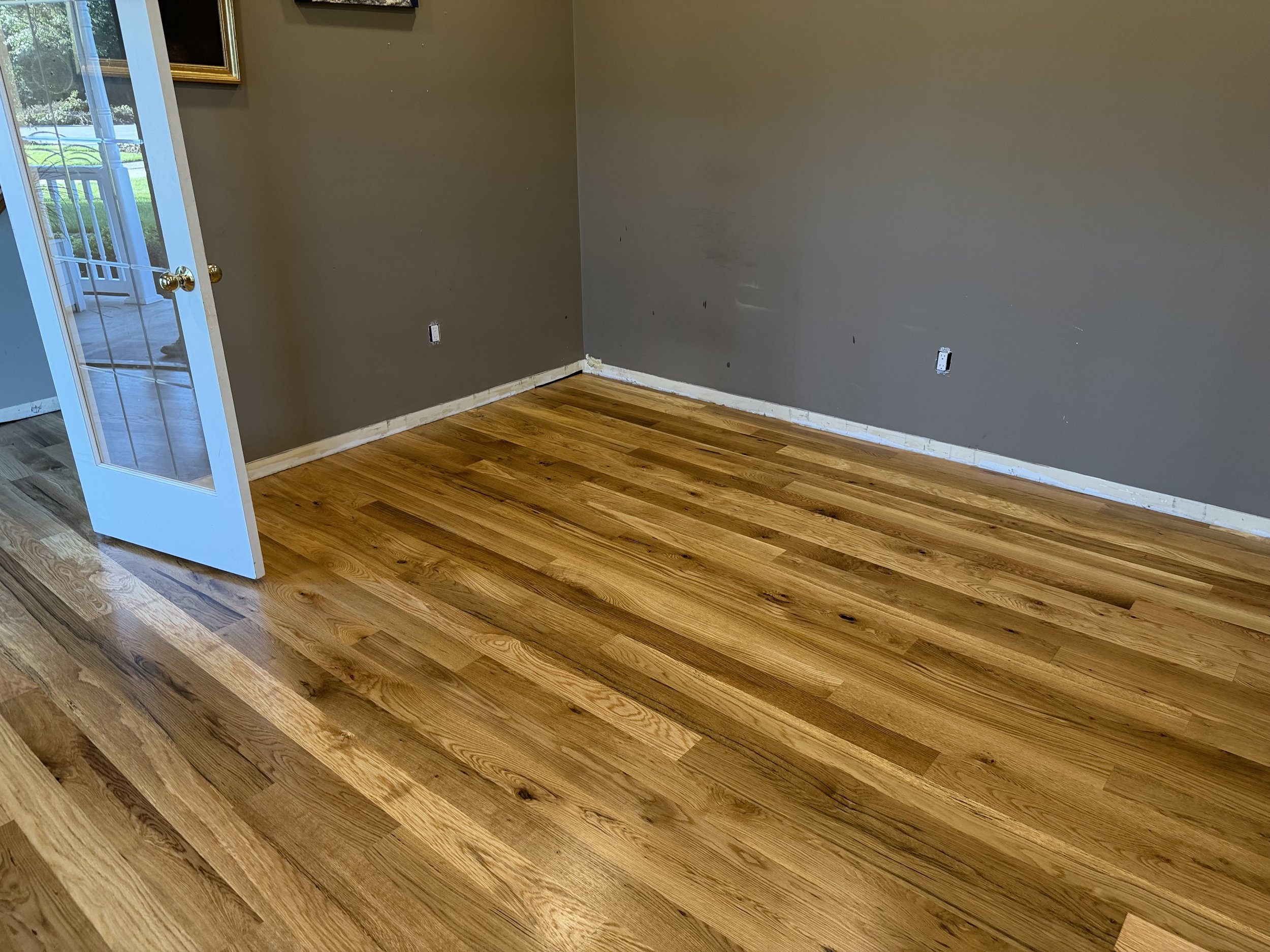 Refinished hardwood flooring with a renewed natural tone and durable protective finish in a Sugar Grove home