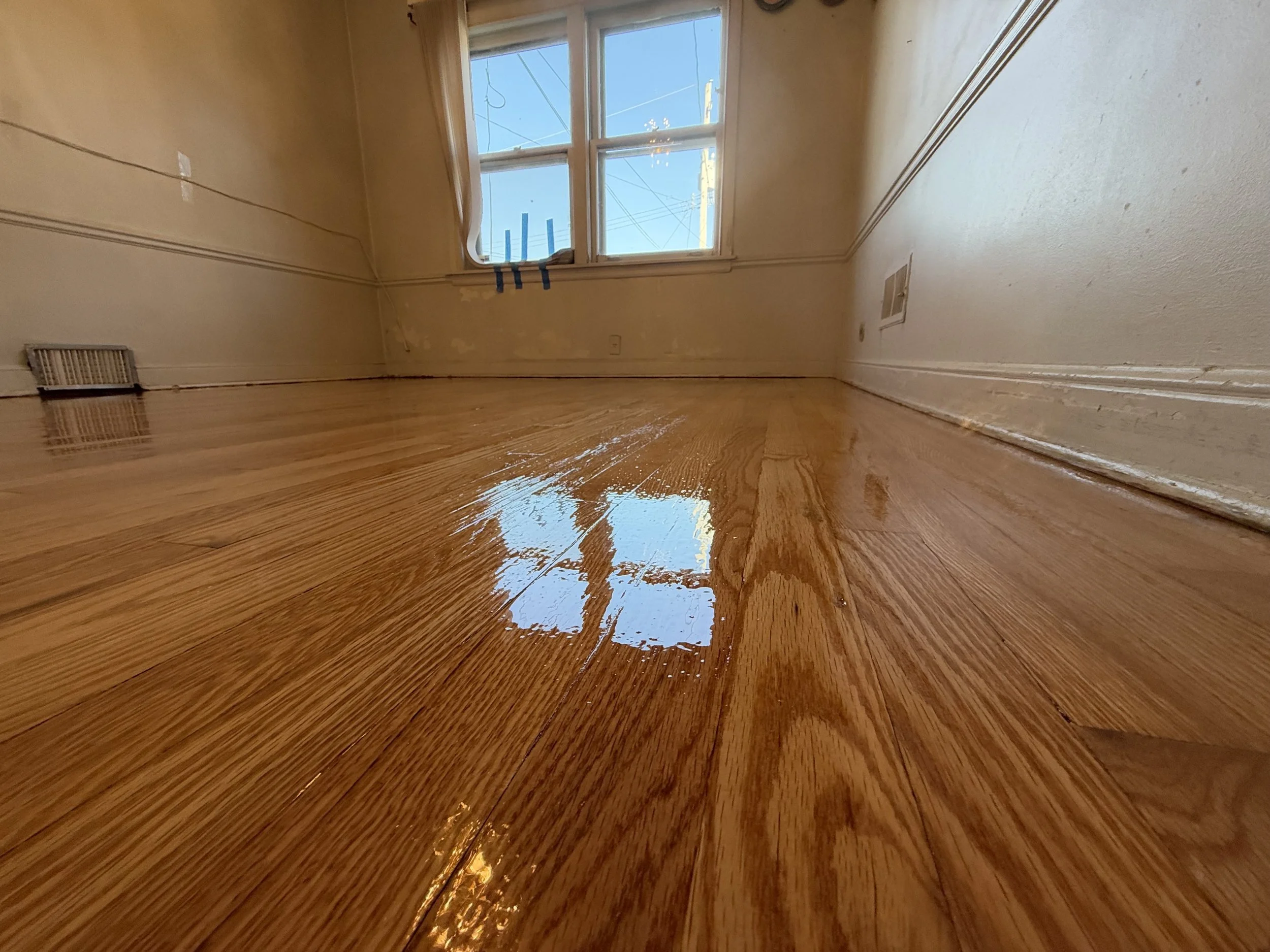 Refinished hardwood floor showing natural wood grain and a renewed protective finish in Bartlett, Illinois