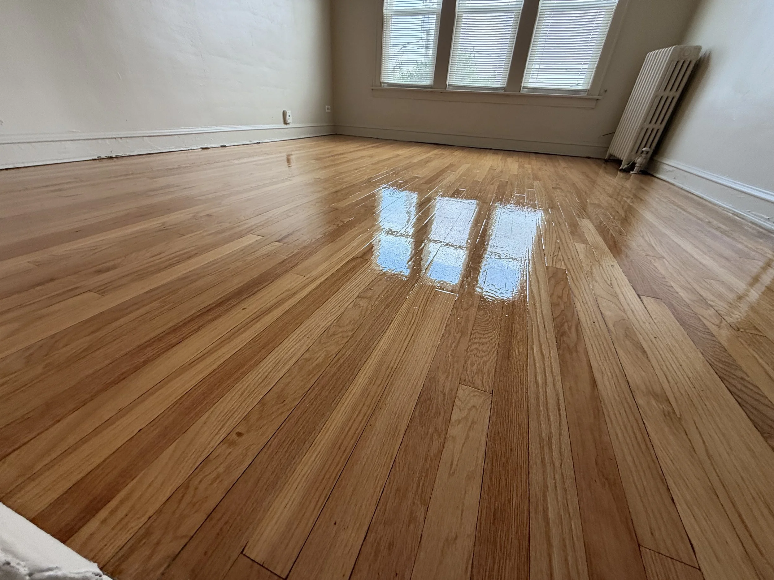 Refinished hardwood floor with restored natural grain and durable protective finish in a Willowbrook home