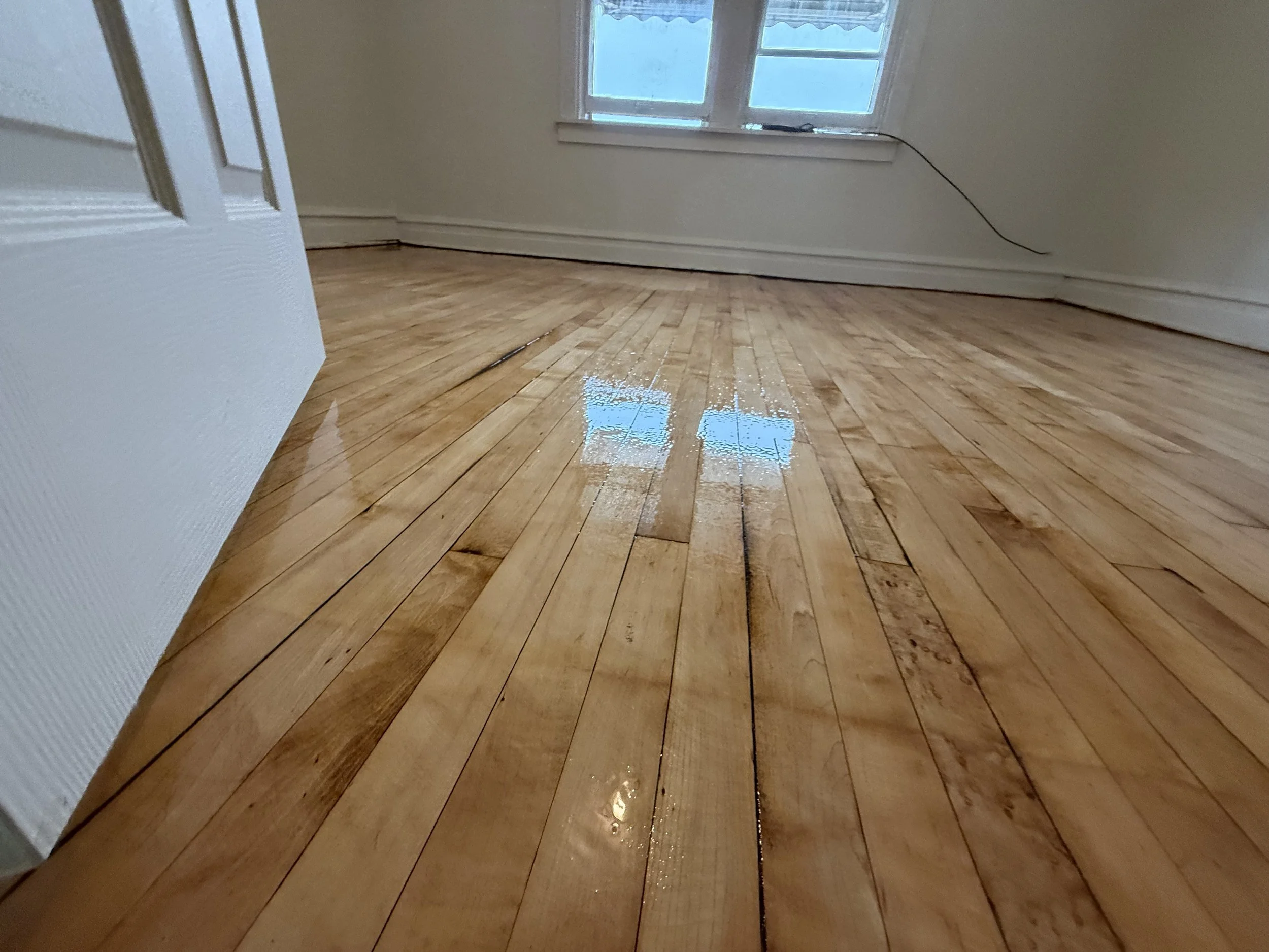 Refinished hardwood flooring with restored wood grain and a durable protective finish in a Clarendon Hills home