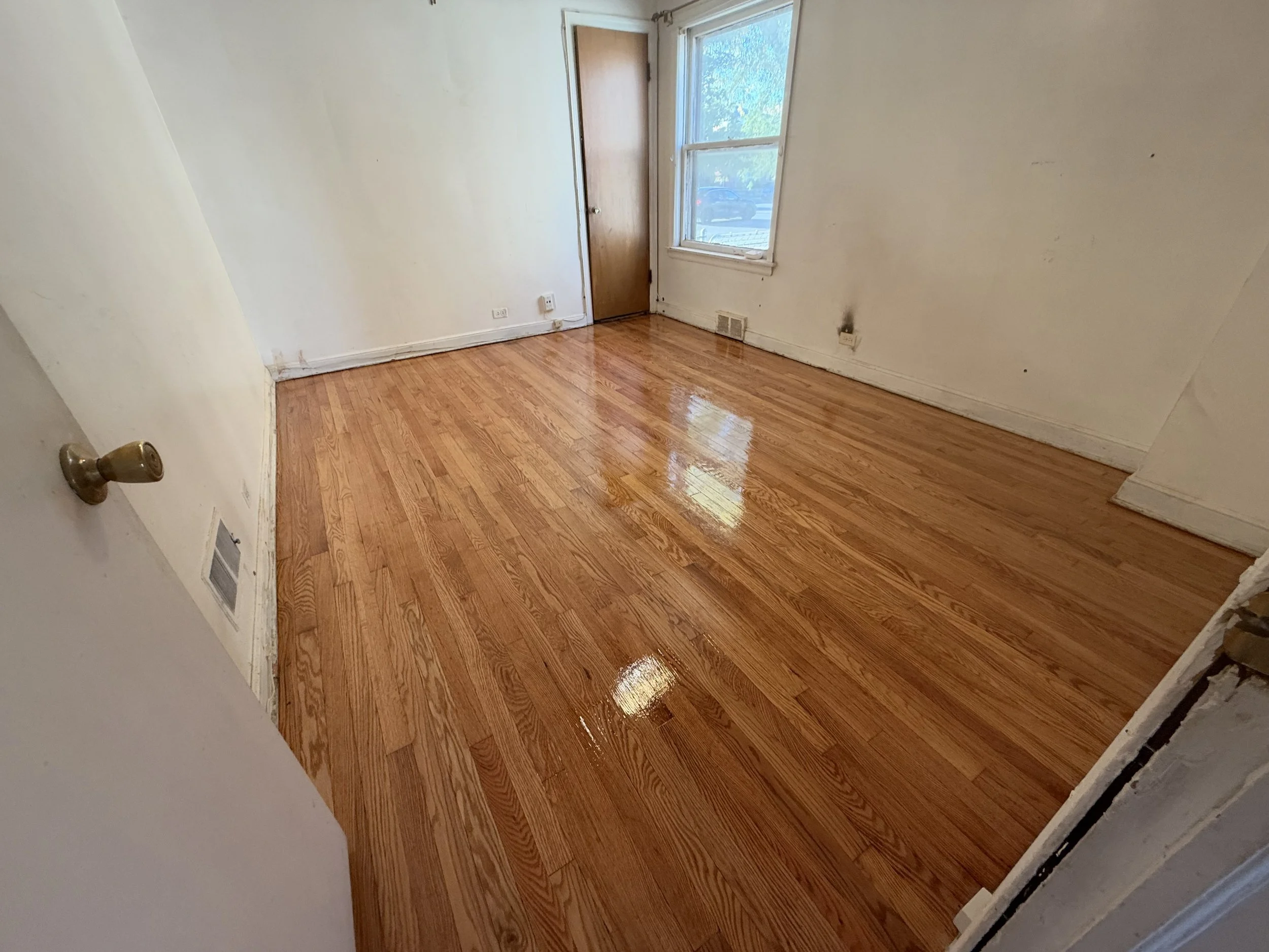 Hardwood floor refinished to restore its color and protect the wood in a Hanover Park home