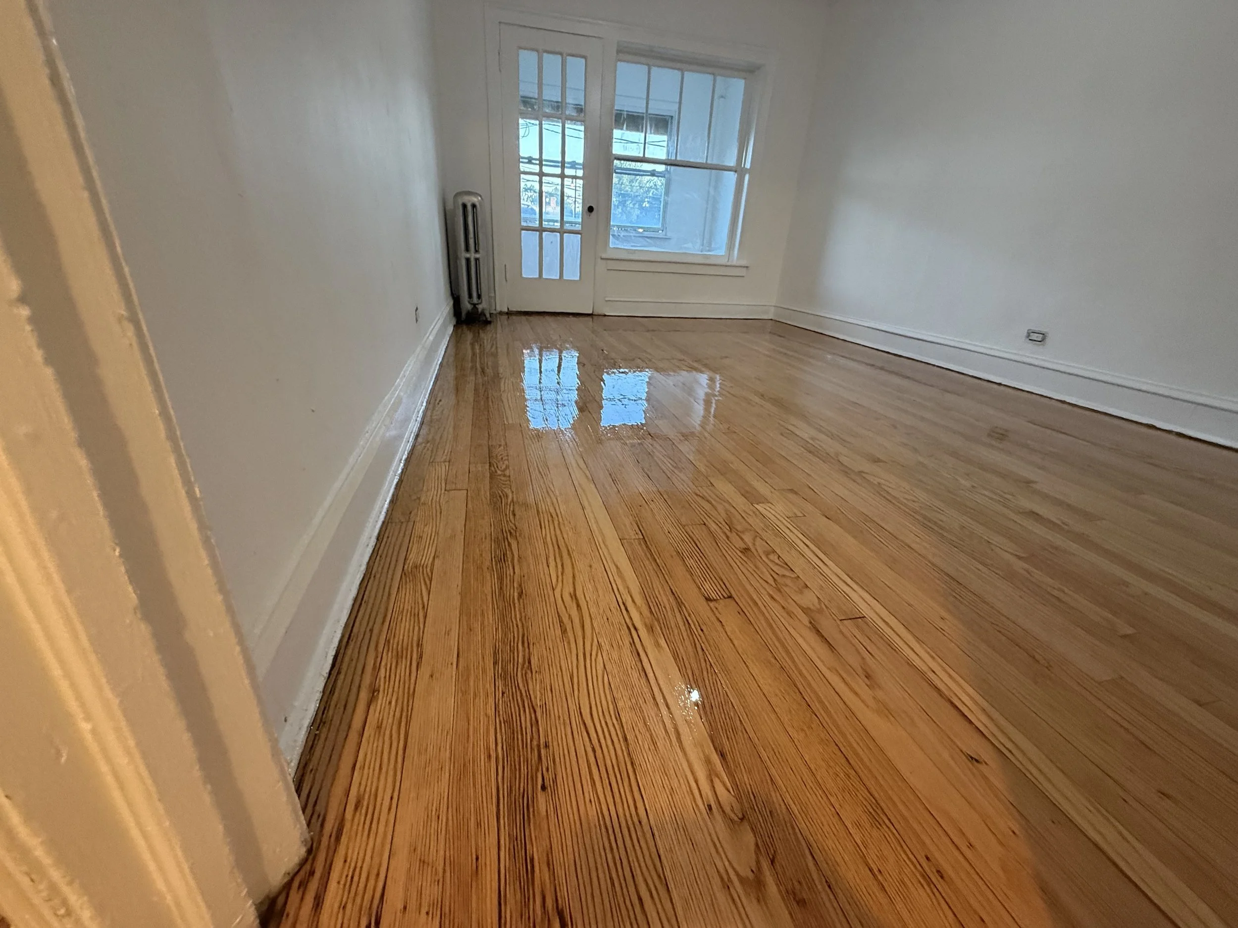 Refinished hardwood flooring with renewed natural grain and a durable protective coating in a Millbrook home