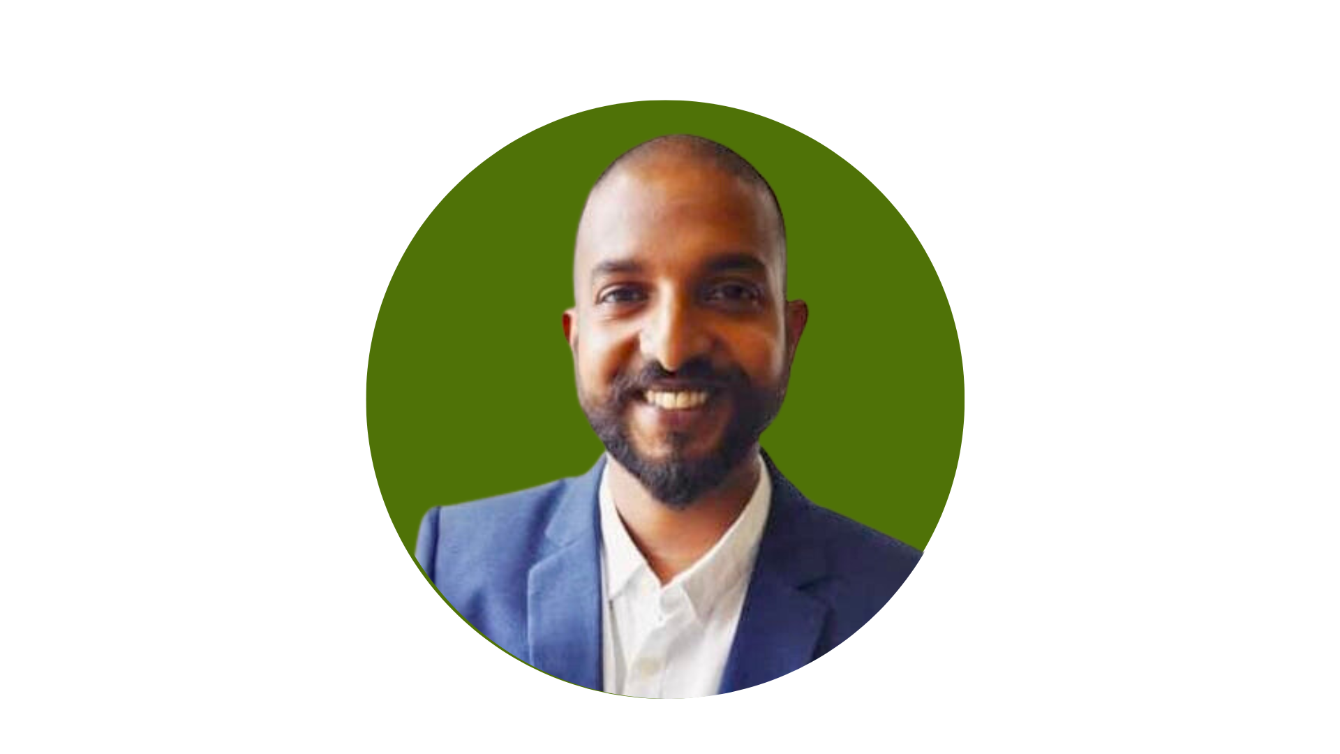 Headshot of a smiling man with a beard, wearing a formal suit and white shirt, against a green circular background.