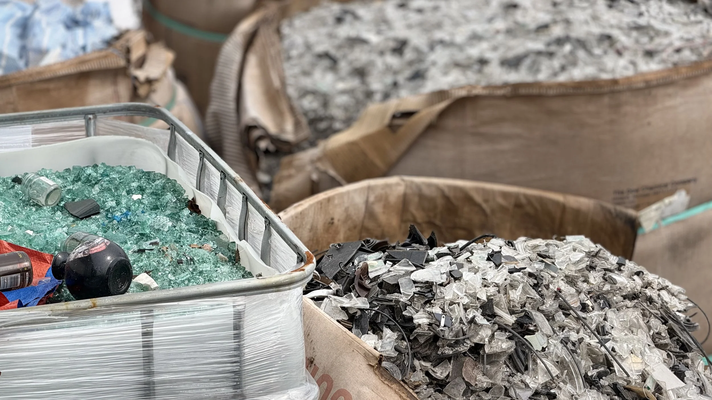 Baskets of broken glass and scrap metal, likely for recycling or disposal.