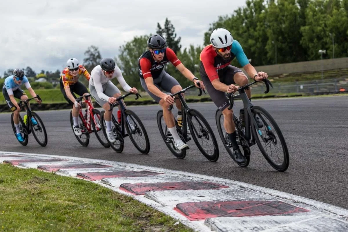 Group of cyclists racing on a criterium circuit, including Blair competing in a road race