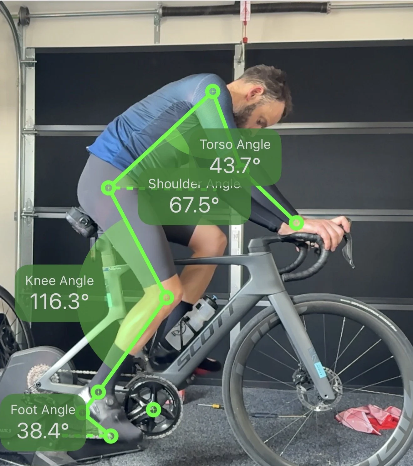 Side view of a road cyclist during a basic bike fit, with position markings.