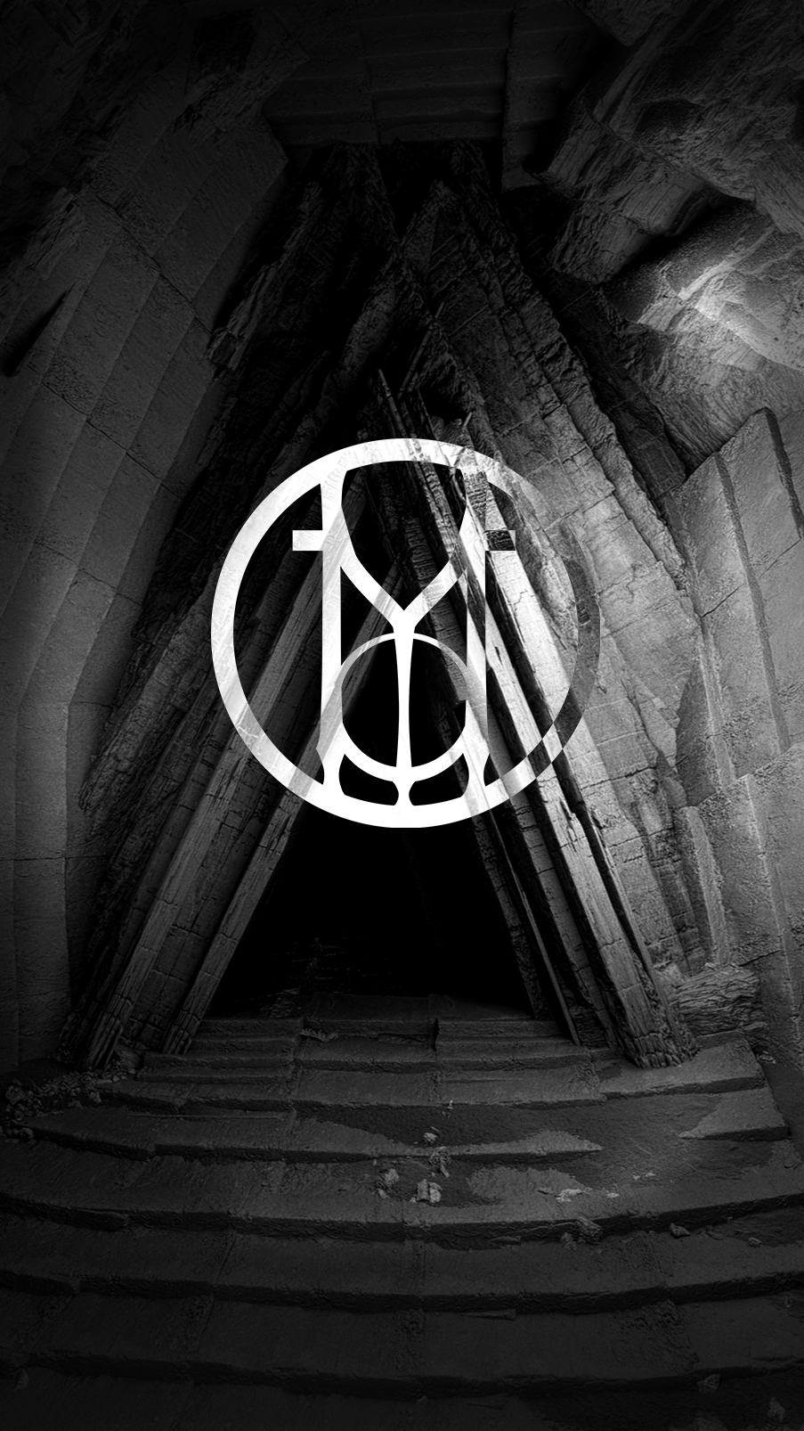 Black and white photograph of a stone architectural structure with stairs leading up to a dark entrance, overlaid with a white, abstract geometric logo.