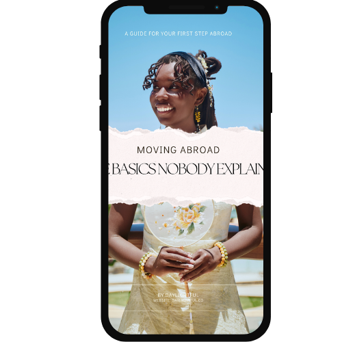 A young woman smiling outdoors on a sunny day, with a guidebook about moving abroad on a smartphone screen in front of her.