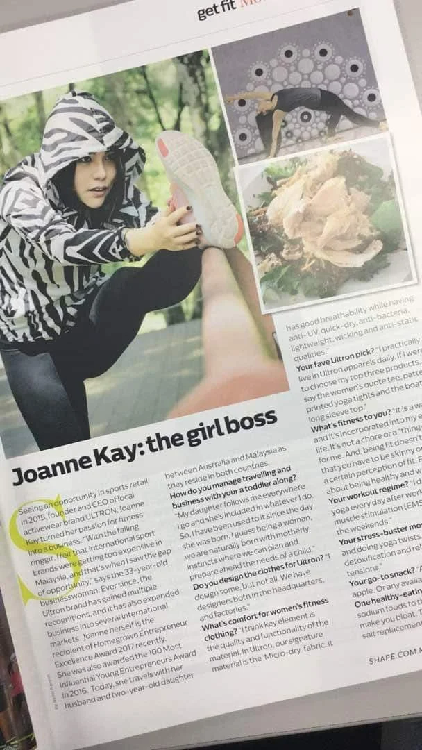 A woman in a zebra print hoodie stretching outdoors, with a magazine page featuring a yoga pose, a woman doing yoga, and a decorative food dish.