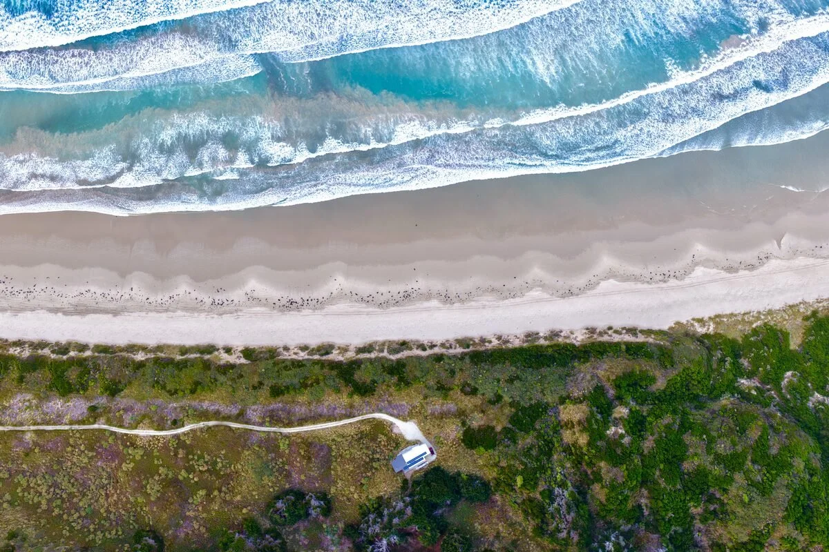 Cloudy Bay, Bruny Island, Tasmania, from above: waves, white sand and bushland.