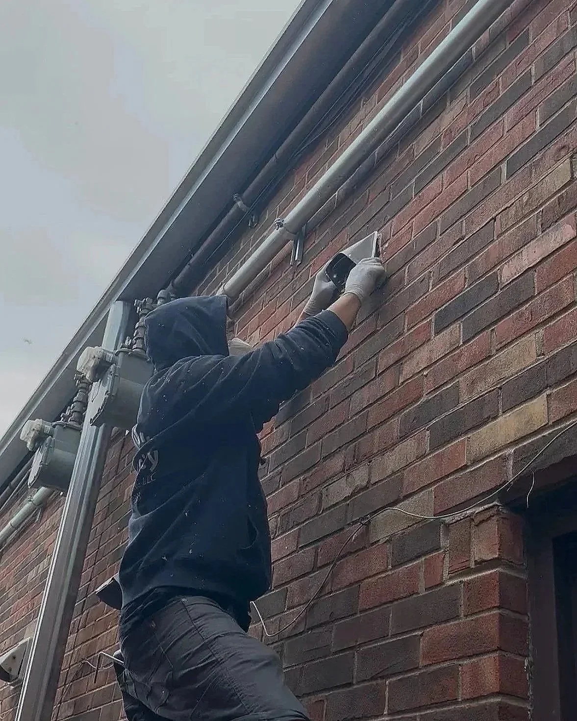 Oranssi technician working on a roof project