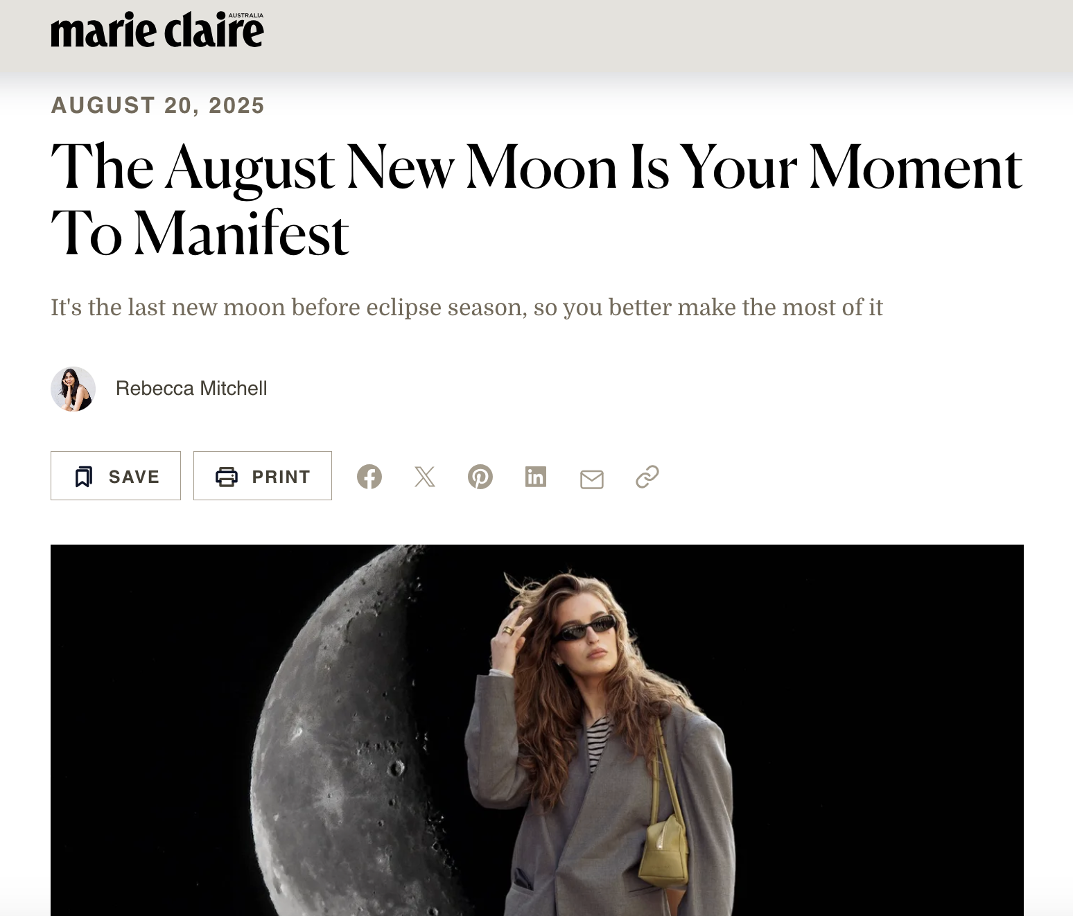 An article by astrology and horoscope writer Rebecca Mitchell on Marie Claire Australia with an image of a woman with long hair wearing sunglasses and a grey coat standing in front of a large image of the moon.