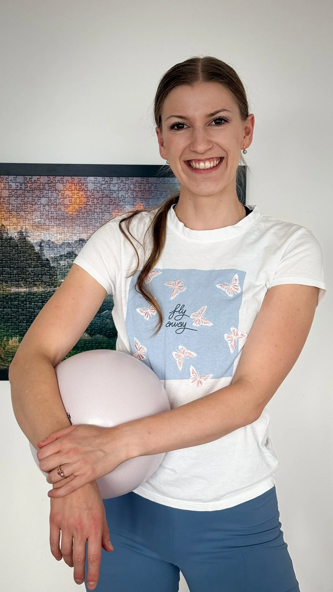 Woman smiling while holding her leg.