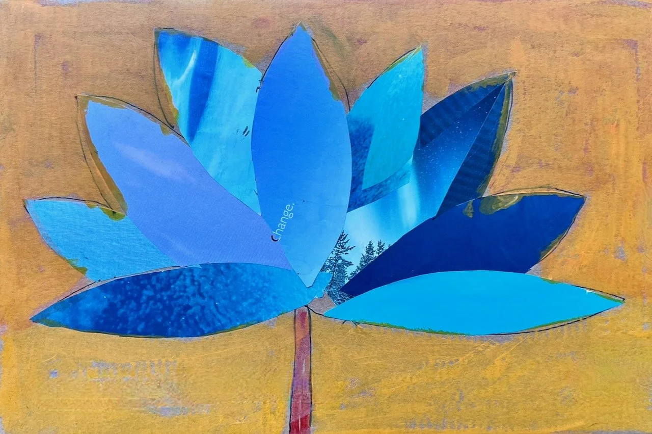 A collage of blue paper cutouts arranged in the shape of a flower with a brown background.