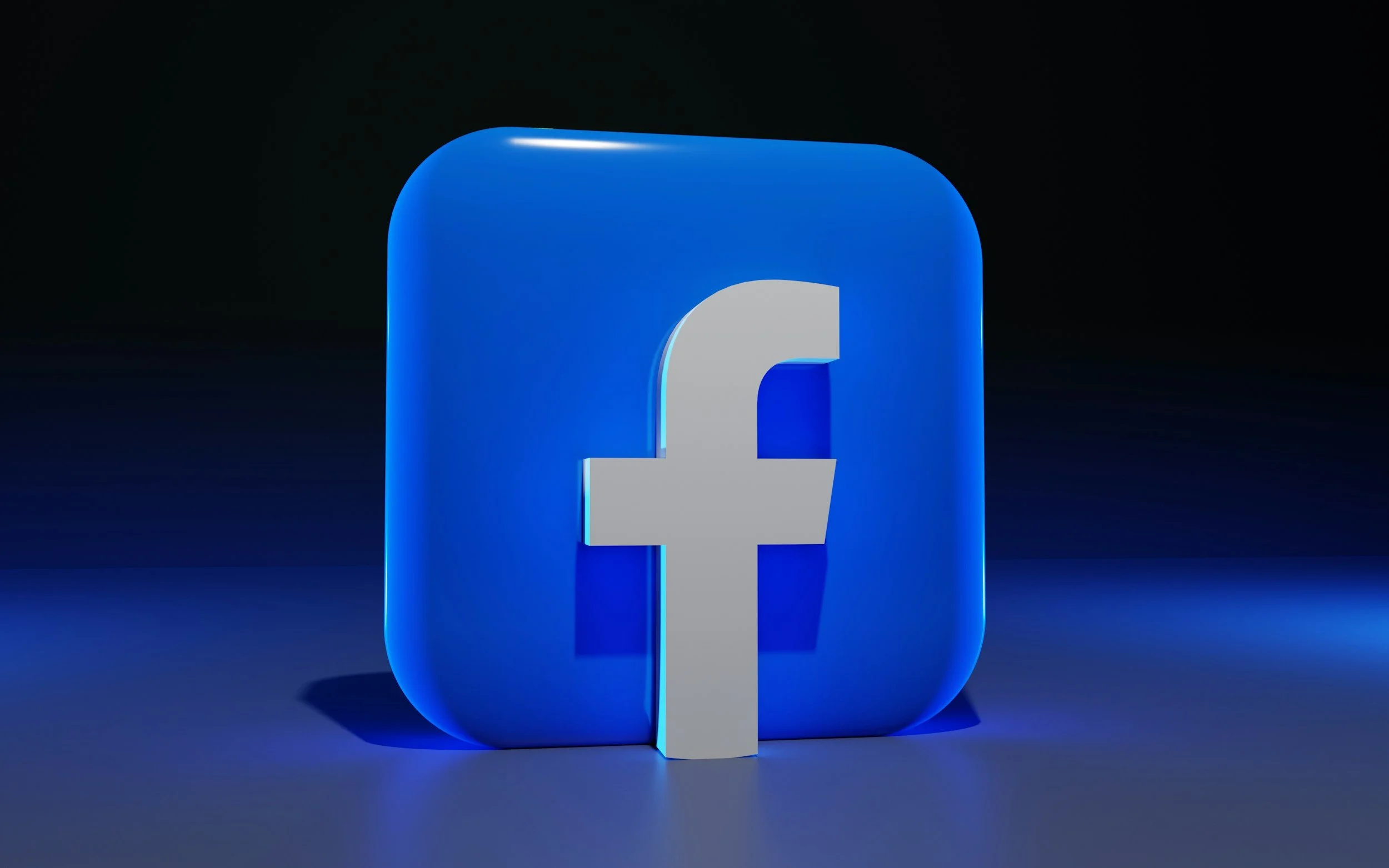 A 3D Facebook logo in blue and gray colors appears on a dark background.