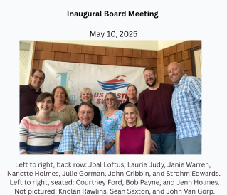 Group photo of eight people standing indoors in front of an 'Inaugural Board Meeting' banner, celebrating May 10, 2025, with a USA and American flag logo.