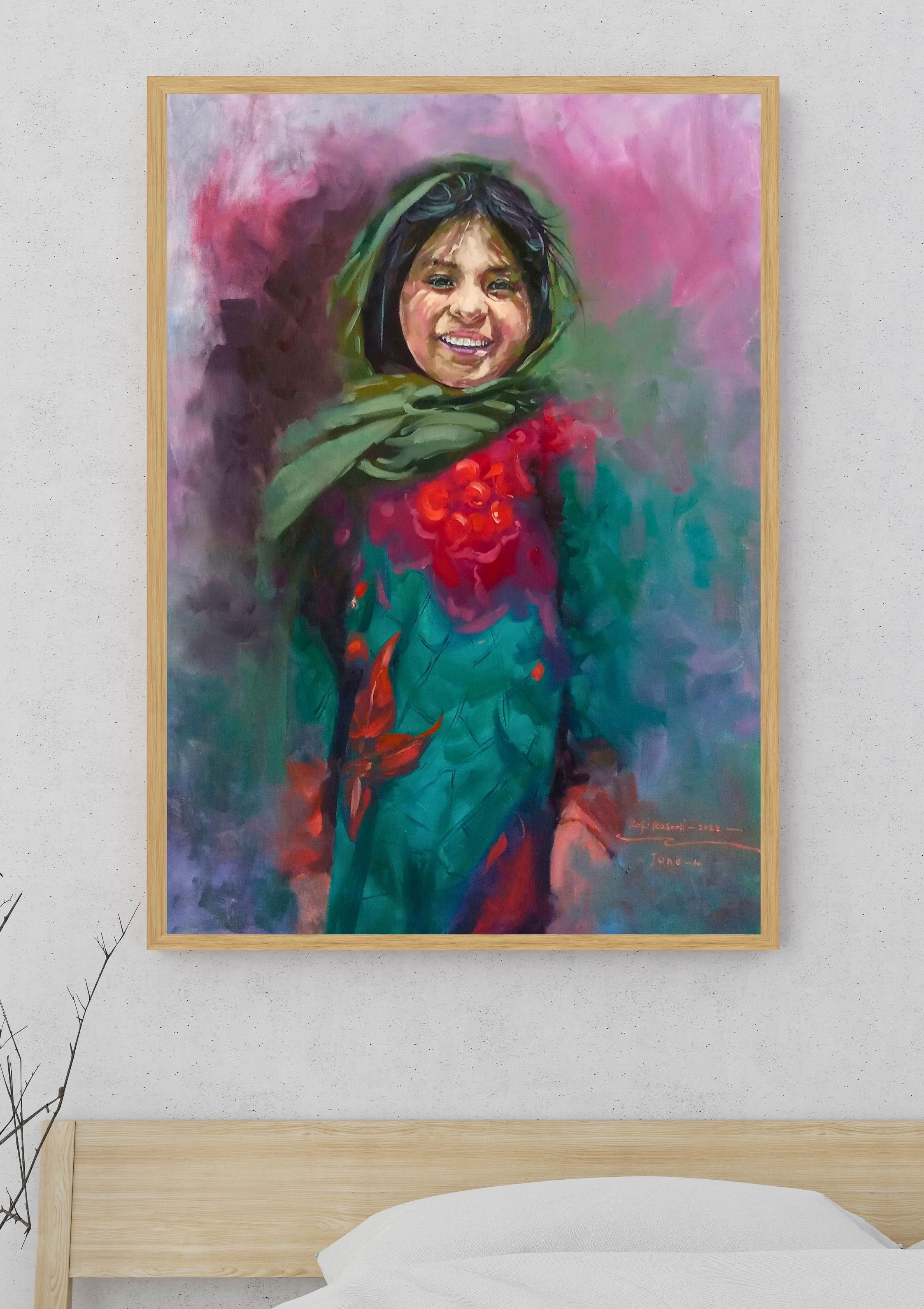 Colorful portrait painting of a smiling child with dark hair, green scarf, and a red garment, hanging on a light-colored wall above a wooden bed with white bedding.