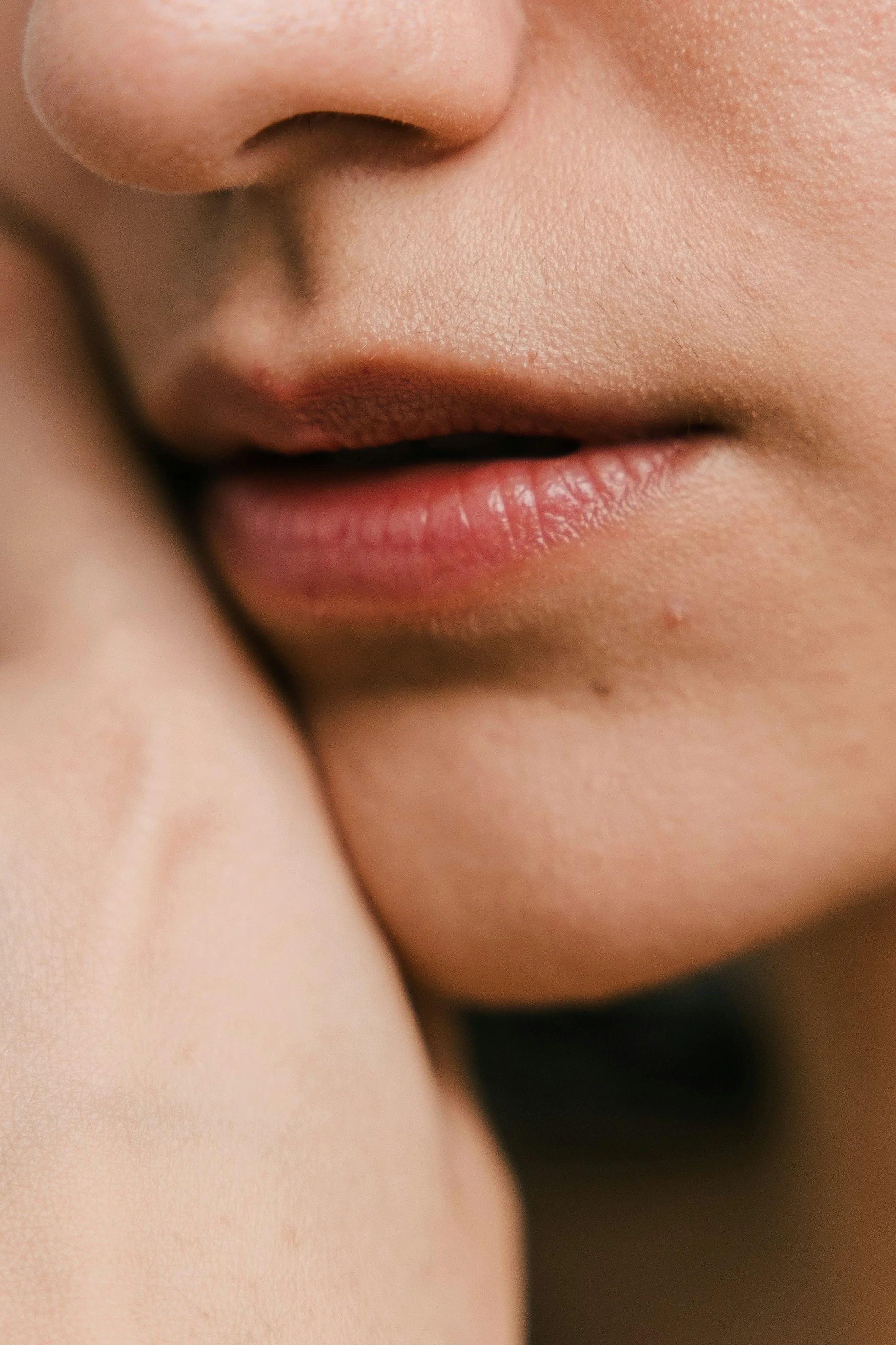 Close-up of lips and nose with soft, natural lip colour and smooth skin, showcasing subtle lip blush results.