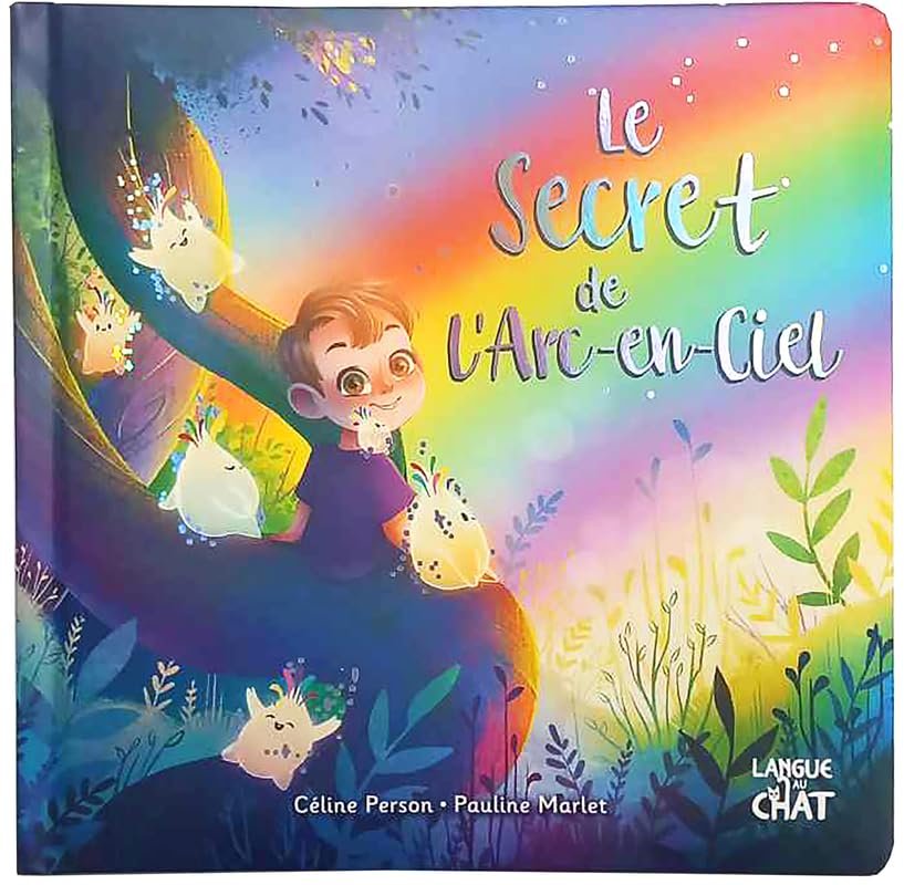 Couverture d'un livre intitulé 'Le secret de l'arc-en-ciel' avec un garçon et des créatures magiques colorées dans un décor féerique.
