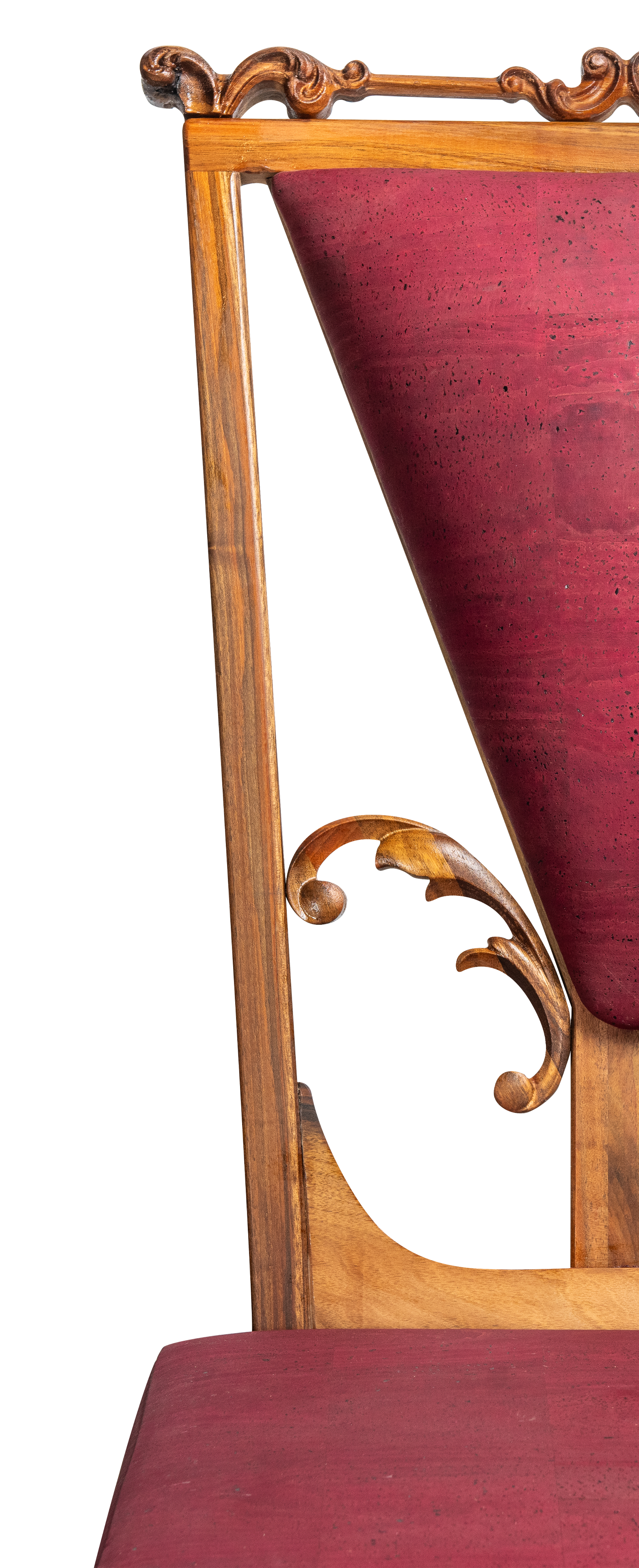 A wooden chair with ornate carved details on the backrest and a red upholstered seat and backrest.