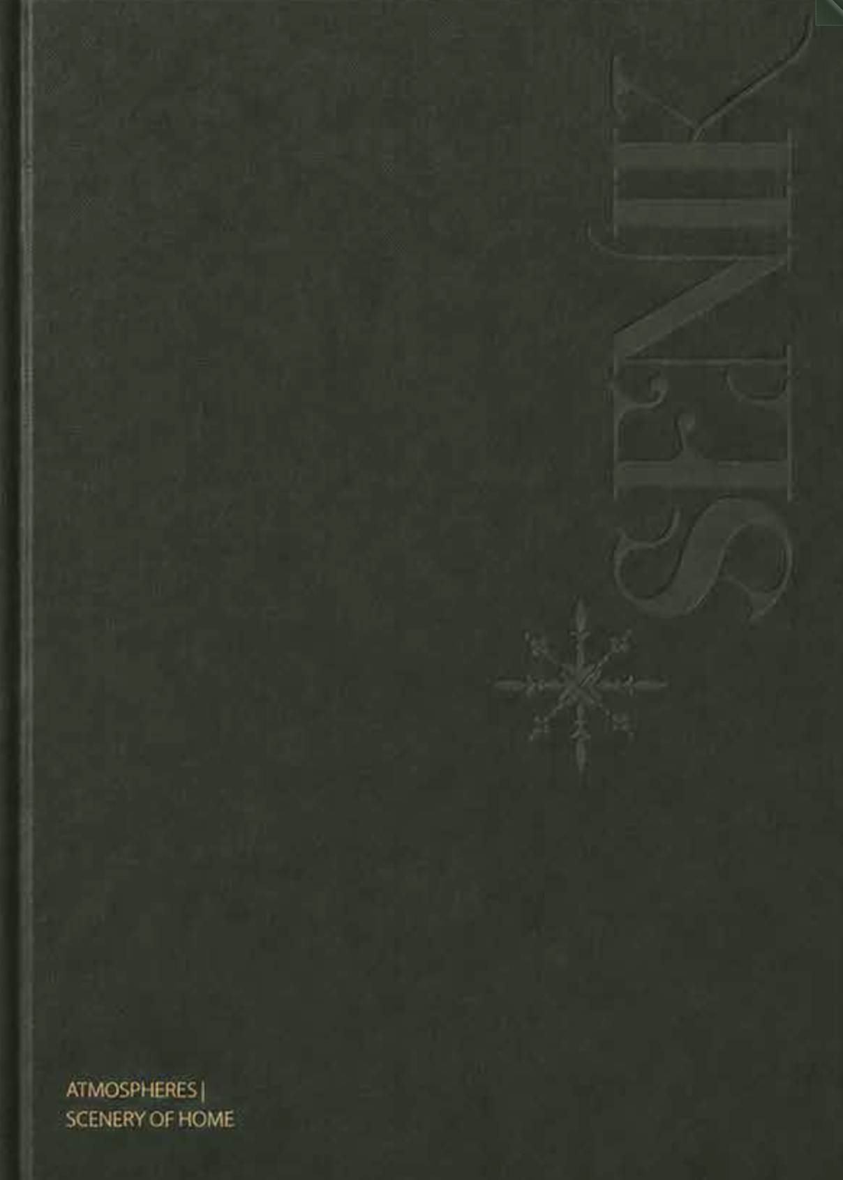 Cover of a book titled 'Atmospheres: Scenery of Home' with a dark background, large stylized 'S' and a snowflake diagram.