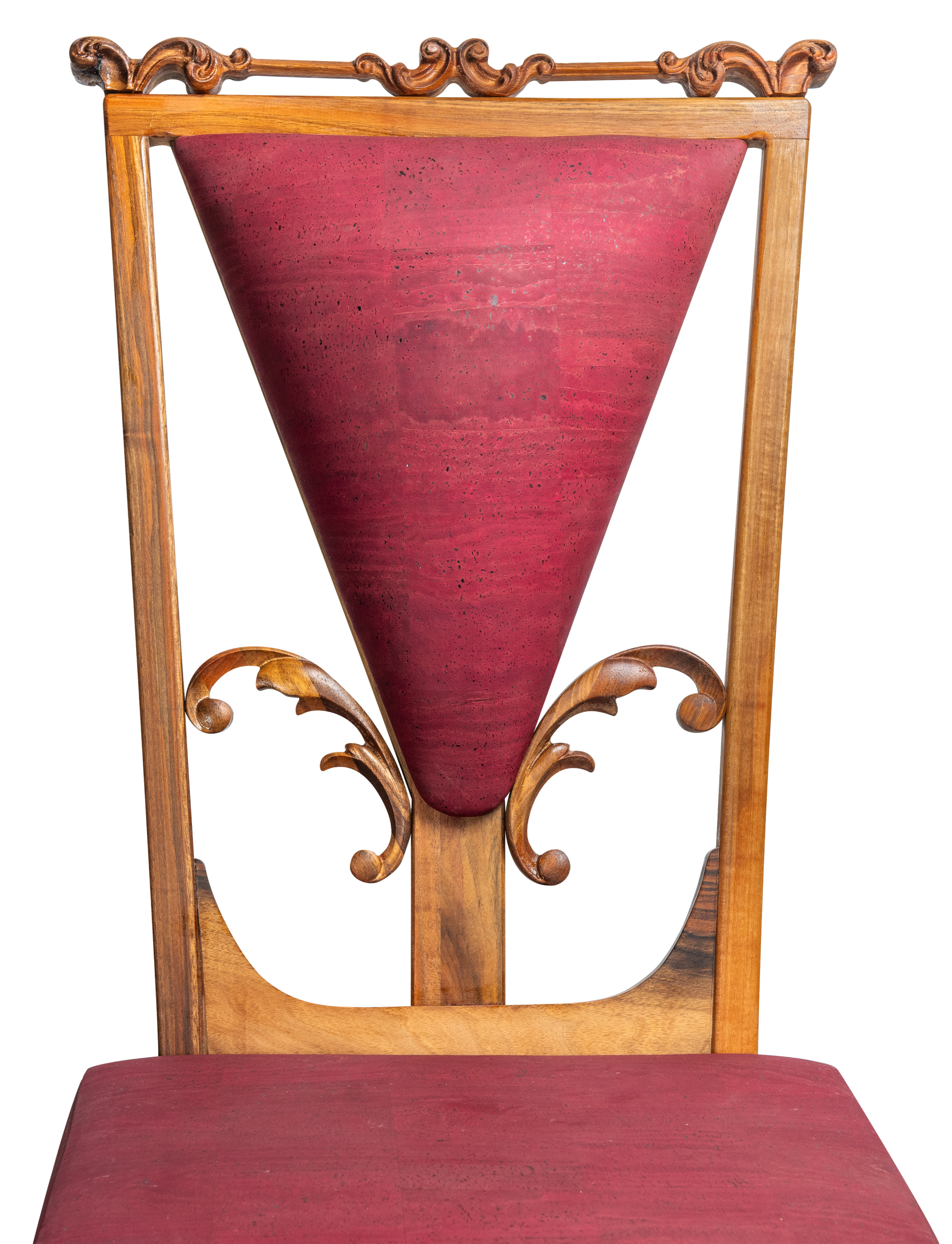 A wooden chair with ornate carvings and a deep red cushioned seat and backrest.