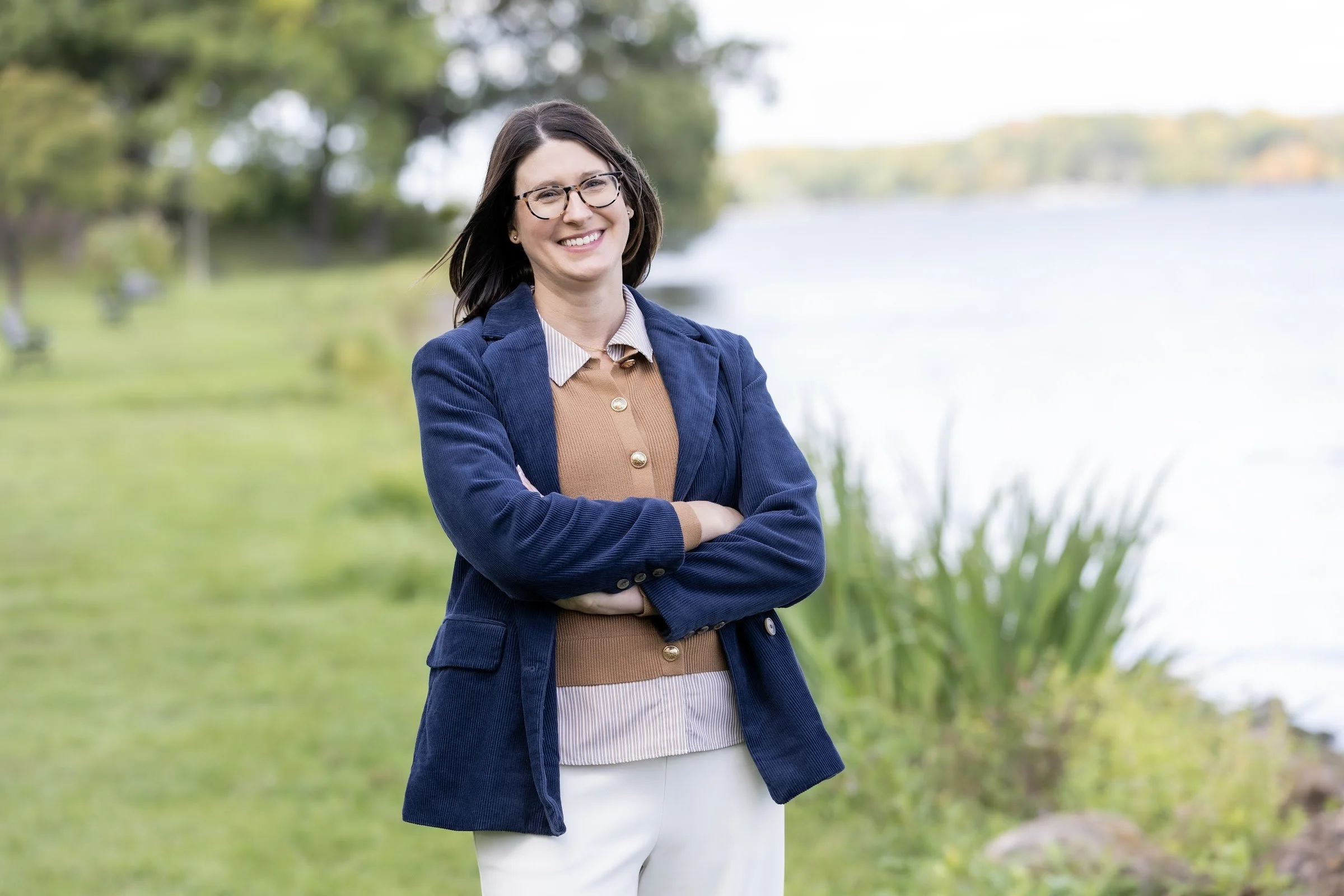 Jill Decker, LPCC, standing lakeside in a navy blazer