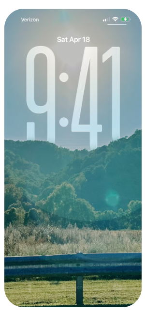 Lock screen of an iPhone showing the date and time, Saturday, April 18 at 9:41 AM, with a background of green trees and blue sky.
