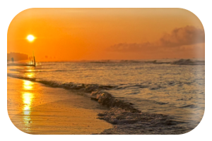 OLED Lock Screen Wallpaper of Sunset over the ocean with a wooden dock and waves gently crashing on the beach.