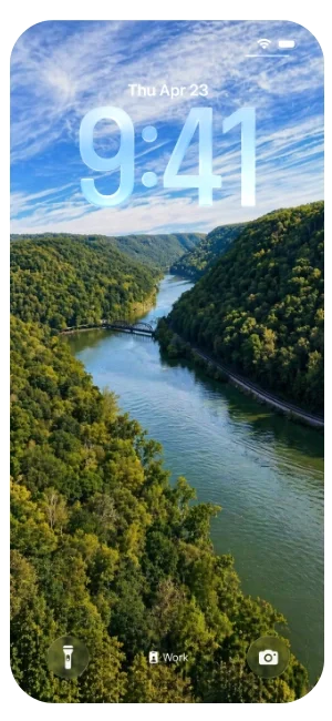 iPhone lock screen displaying a landscape view of a river running through green, forested hills under a partly cloudy sky, with the date and time showing Thursday, April 23, 9:41.