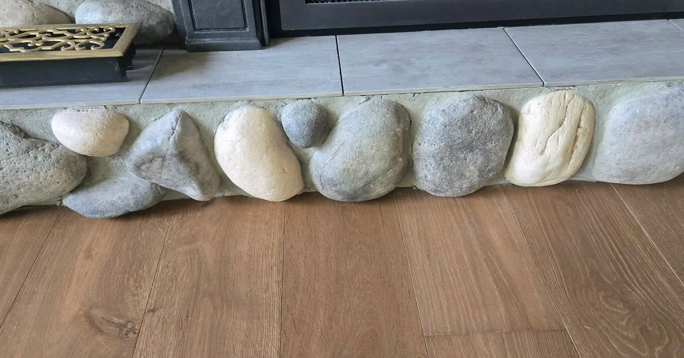 Scribing hardwood around natural river rock is one of those details that takes patience, precision, and skill. Every board was individually cut to follow the shape of the stone, creating a seamless transition without trim or shortcuts.

It&rsquo;s th