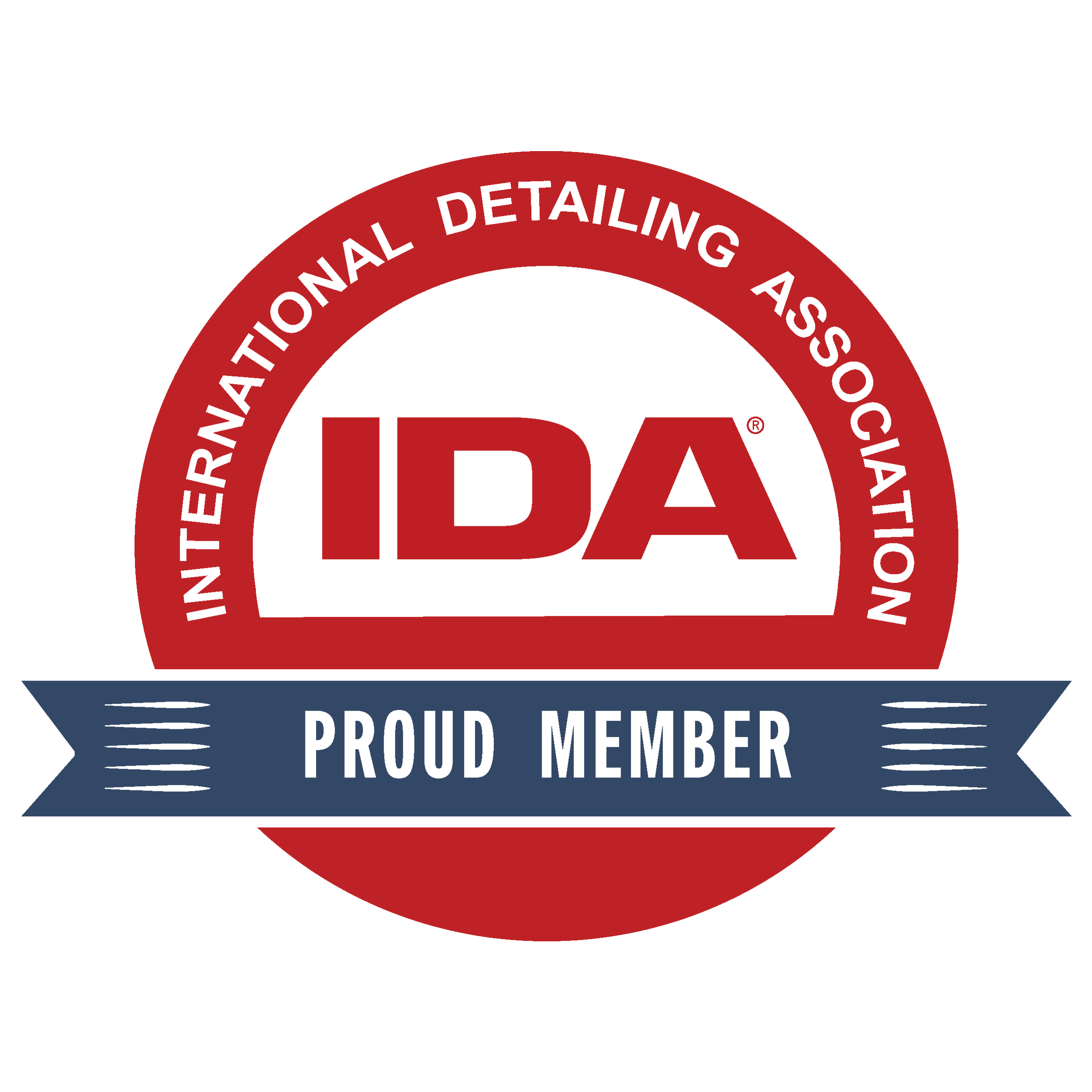 Close-up of a circular badge with a red and navy blue color scheme, featuring text that reads 'Proud Member of the International Detailing Association' around the top edge, and a white center with the initials 'IDA' in red.