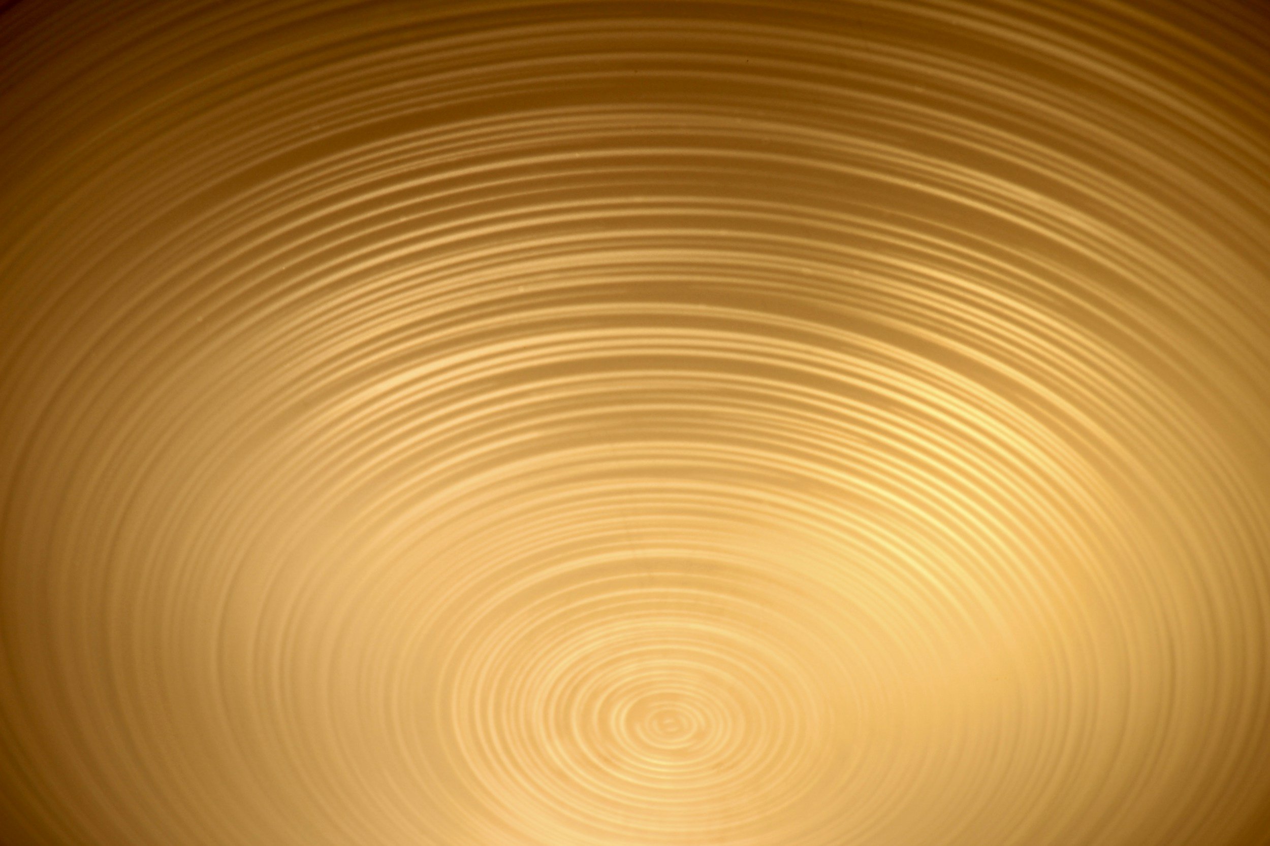 Close-up view of a golden, textured, concentric circle pattern.