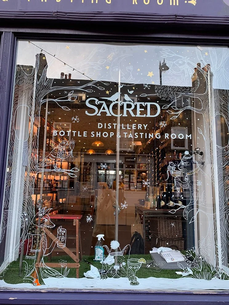 festive window illustration for high end liquor shop by illustrator Stephanie Hofmann