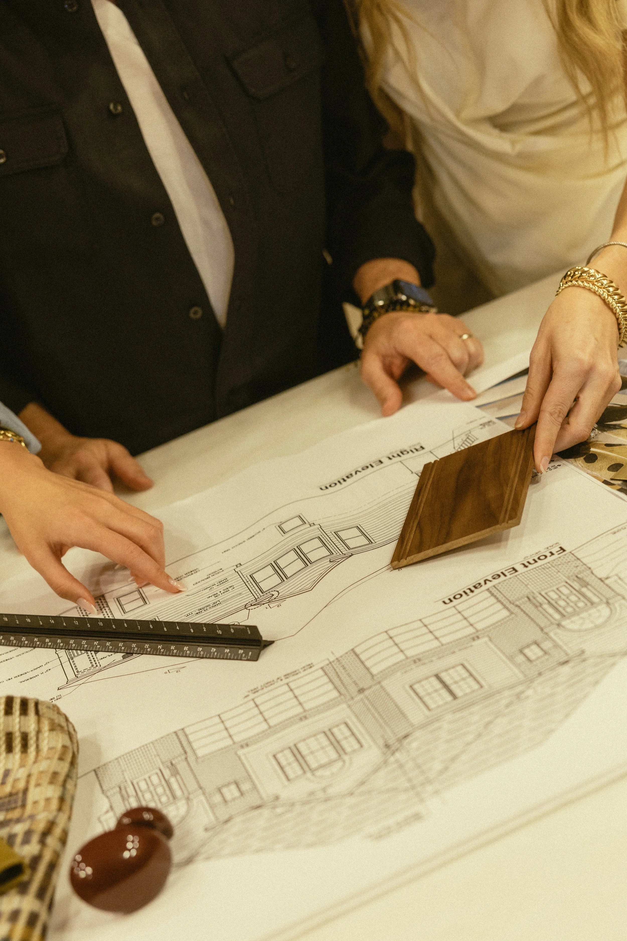 Three team members looking at a floorplan