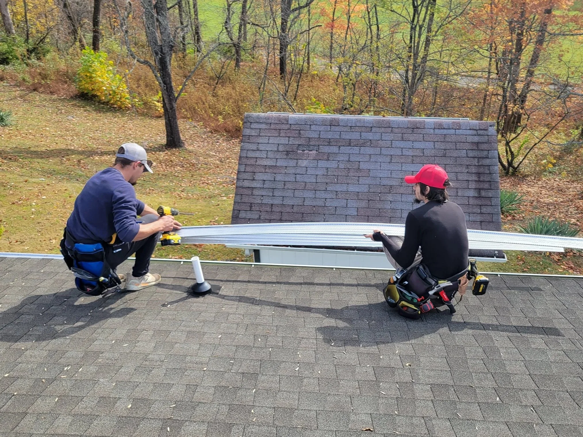Armor Exteriors technicians assessing roof and gutter conditions during exterior maintenance in Upstate South Carolina.