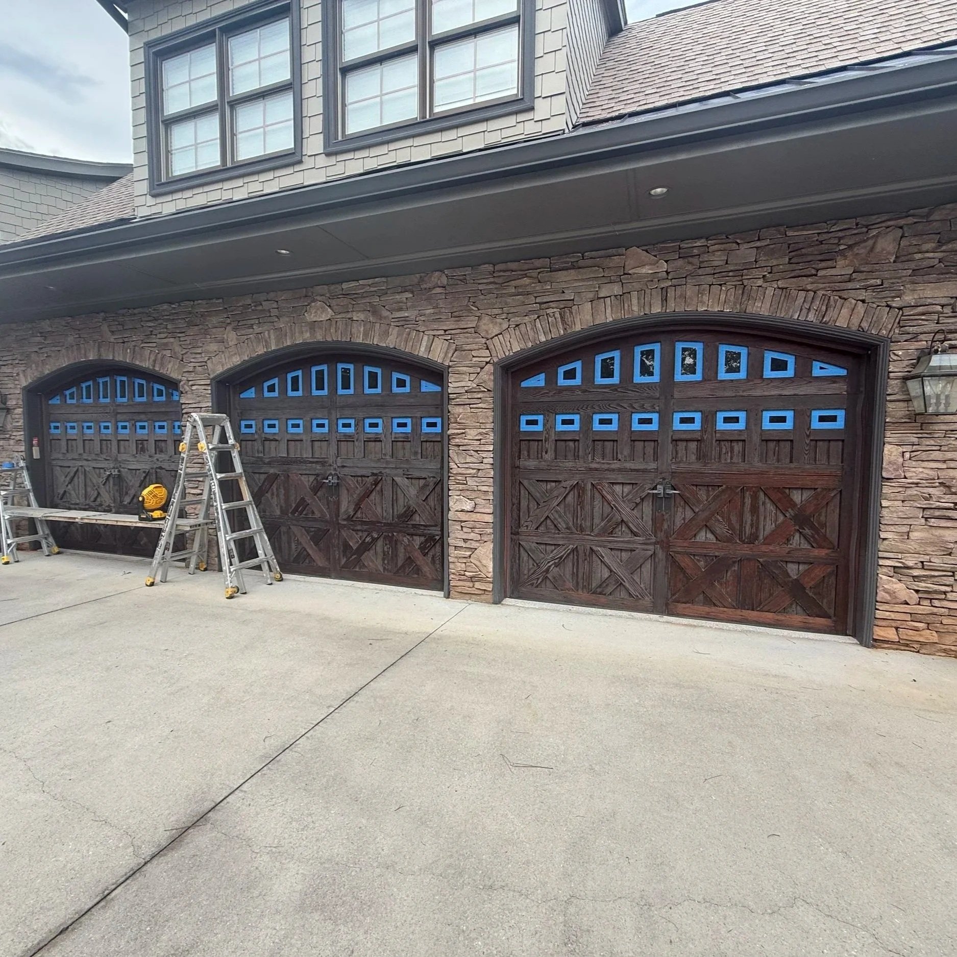 Armor Exteriors technician restoring the exterior finish of a residential garage door in seneca south carolina