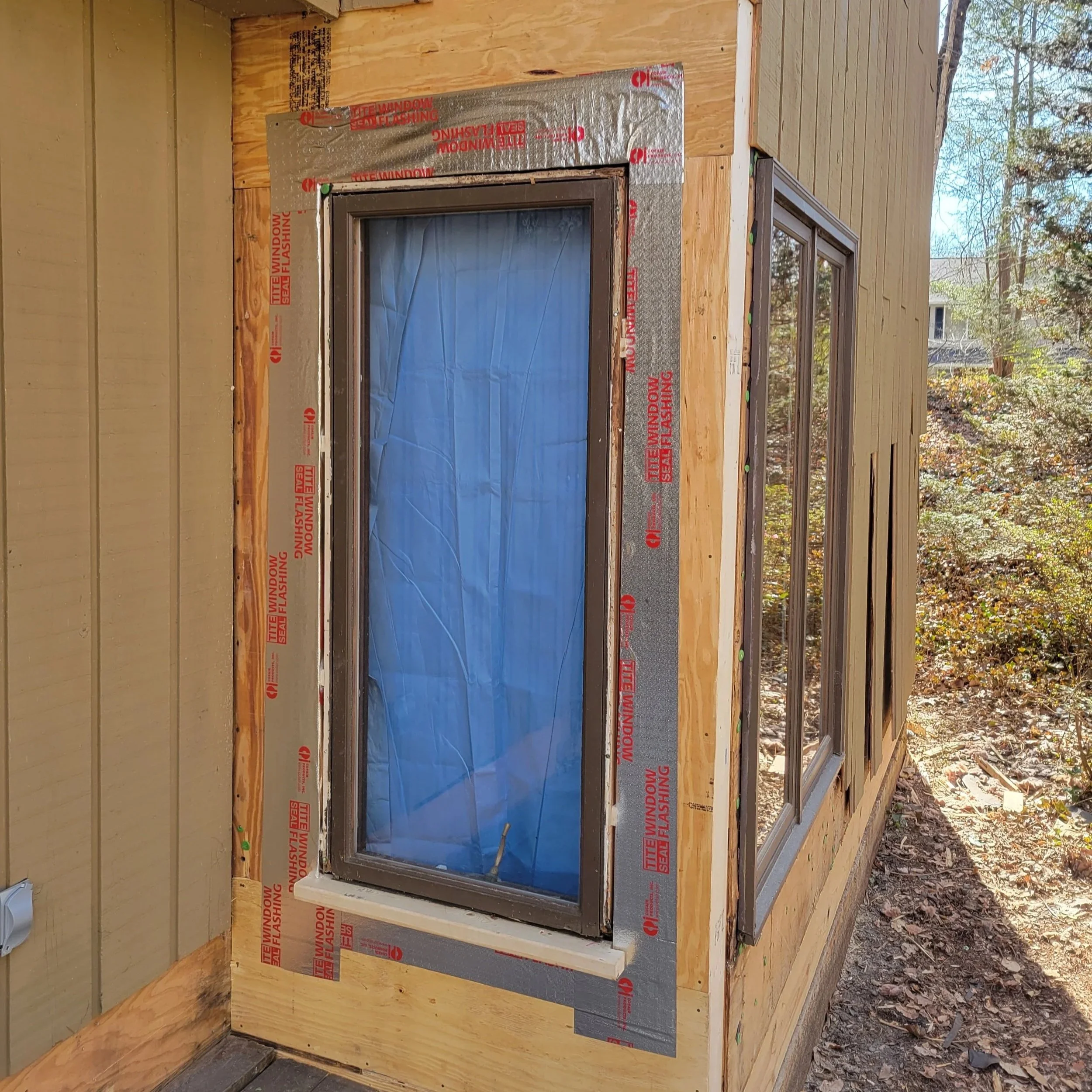 Armor Exteriors technician replacing a residential window on a home in Upstate South Carolina.